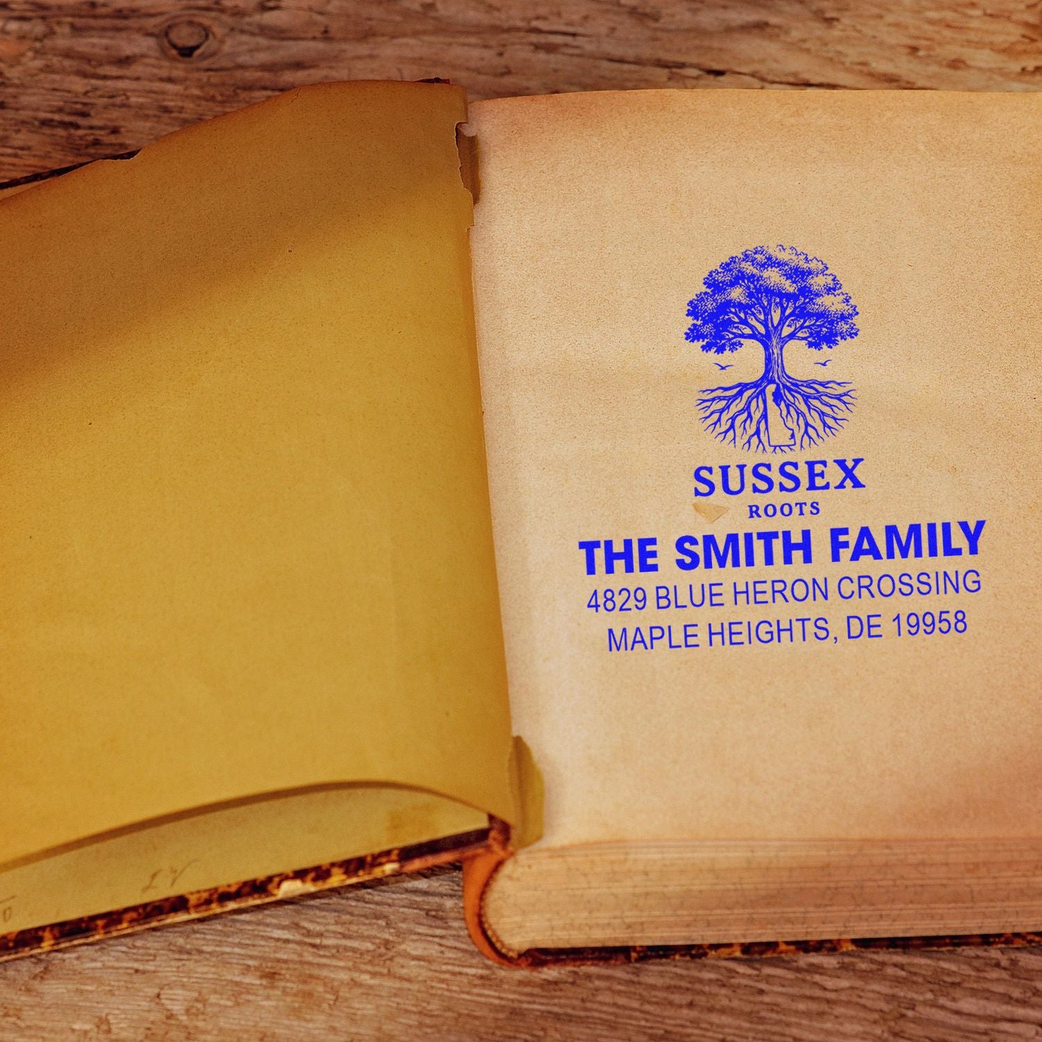 Custom family return address rubber stamp with Sussex Roots tree logo on book page