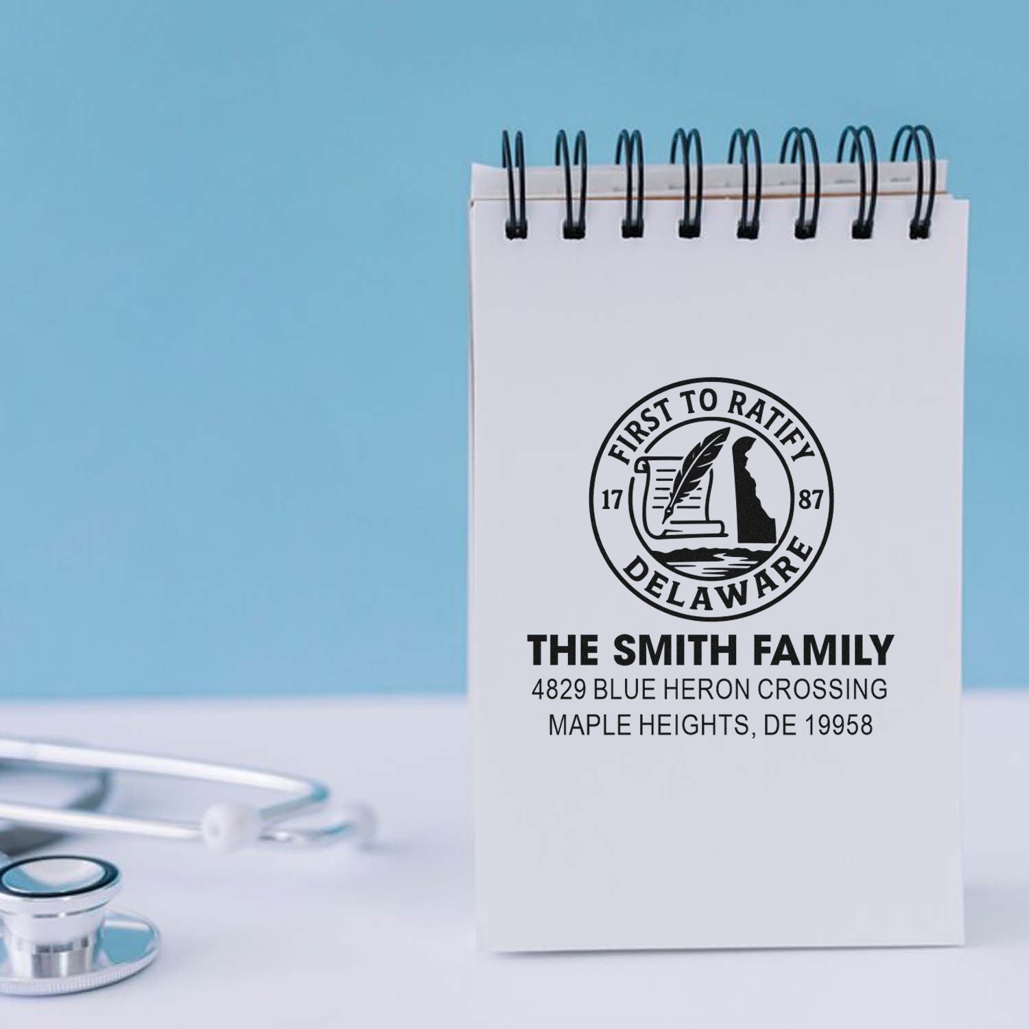 Custom rubber stamp for The Smith Family, featuring Delaware seal and personalized return address on a spiral notebook.