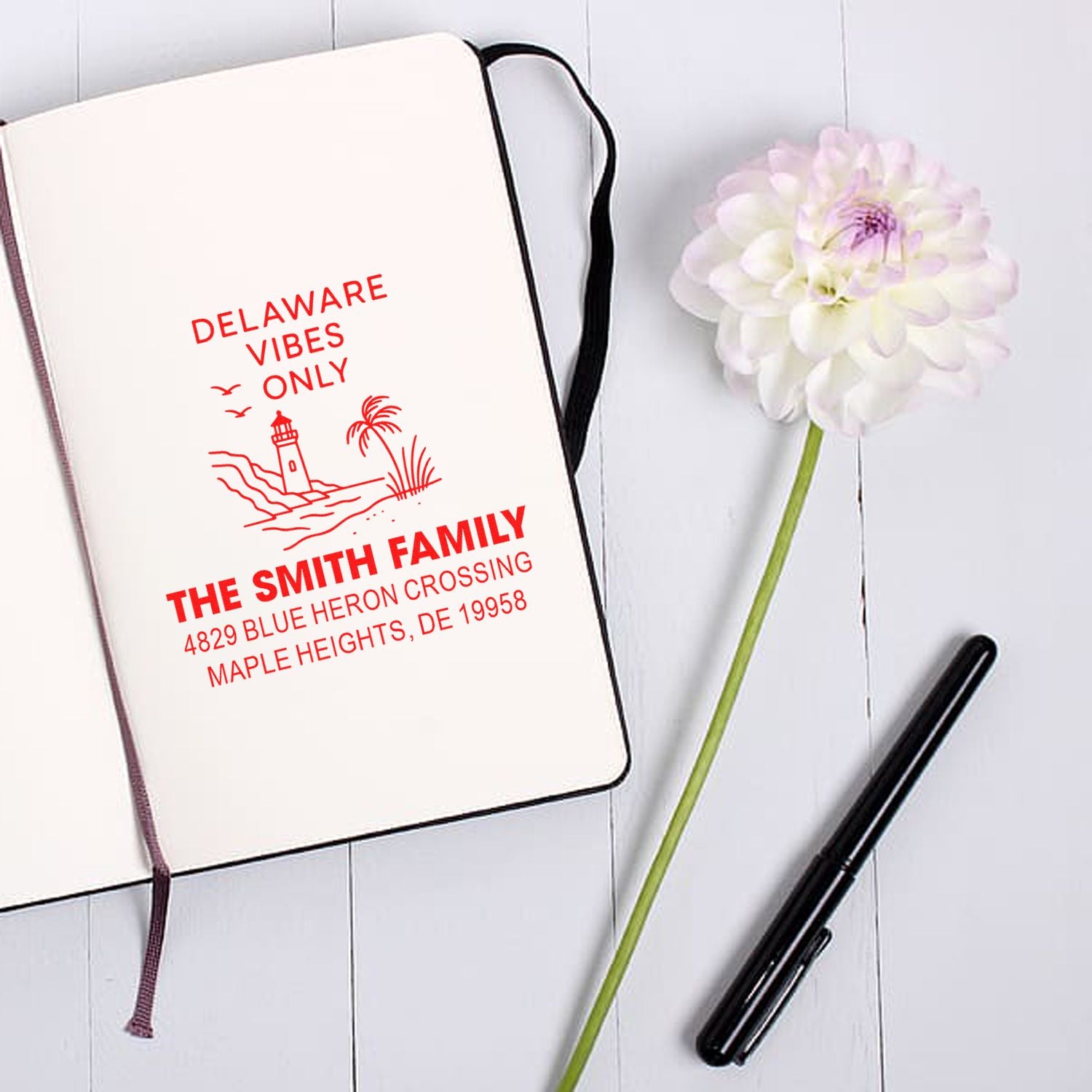 Personalized Delaware beach rubber stamp for The Smith Family with custom address on notebook.