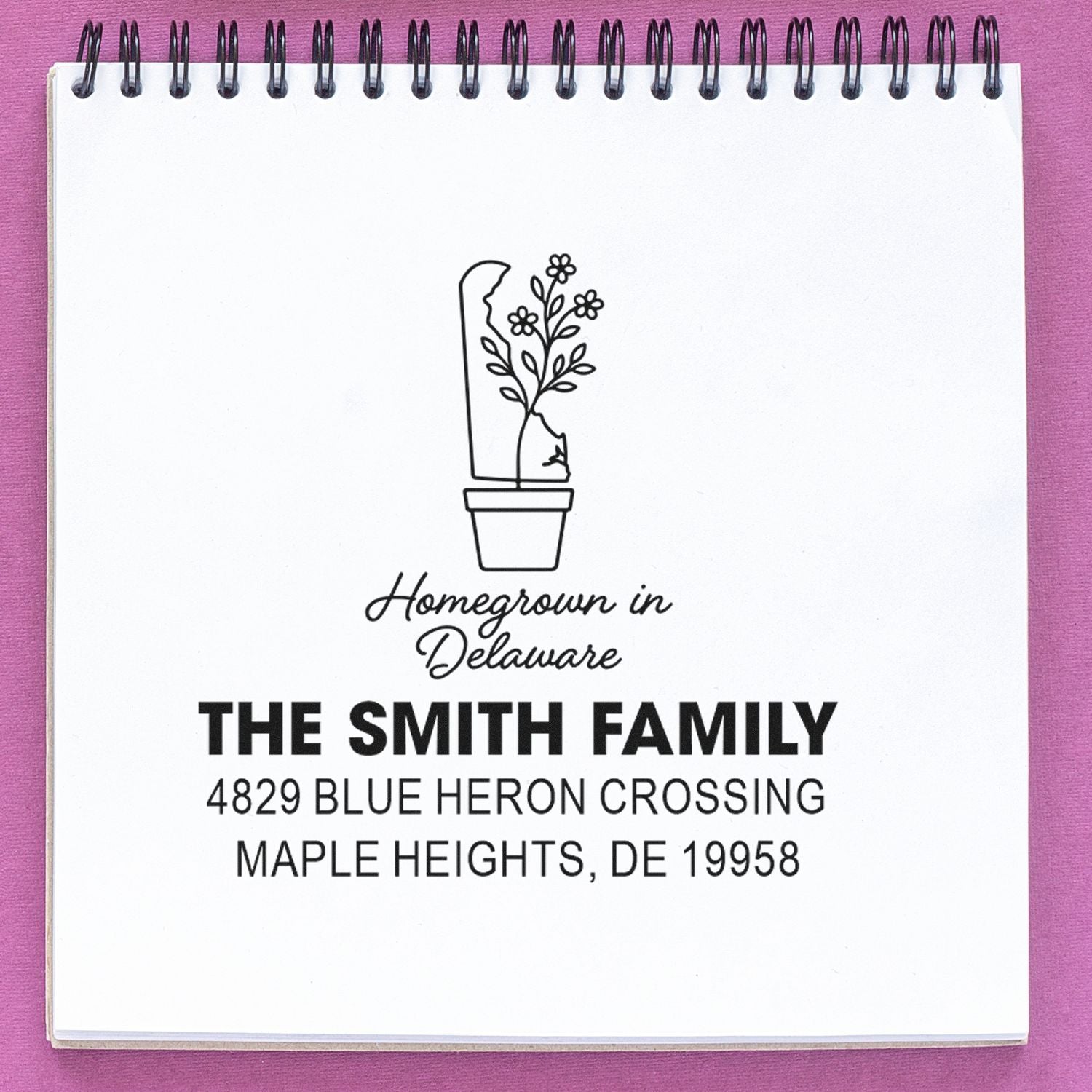 Custom rubber stamp for The Smith Family, featuring a homegrown in Delaware floral pot design and address, Maple Heights, DE 19958.