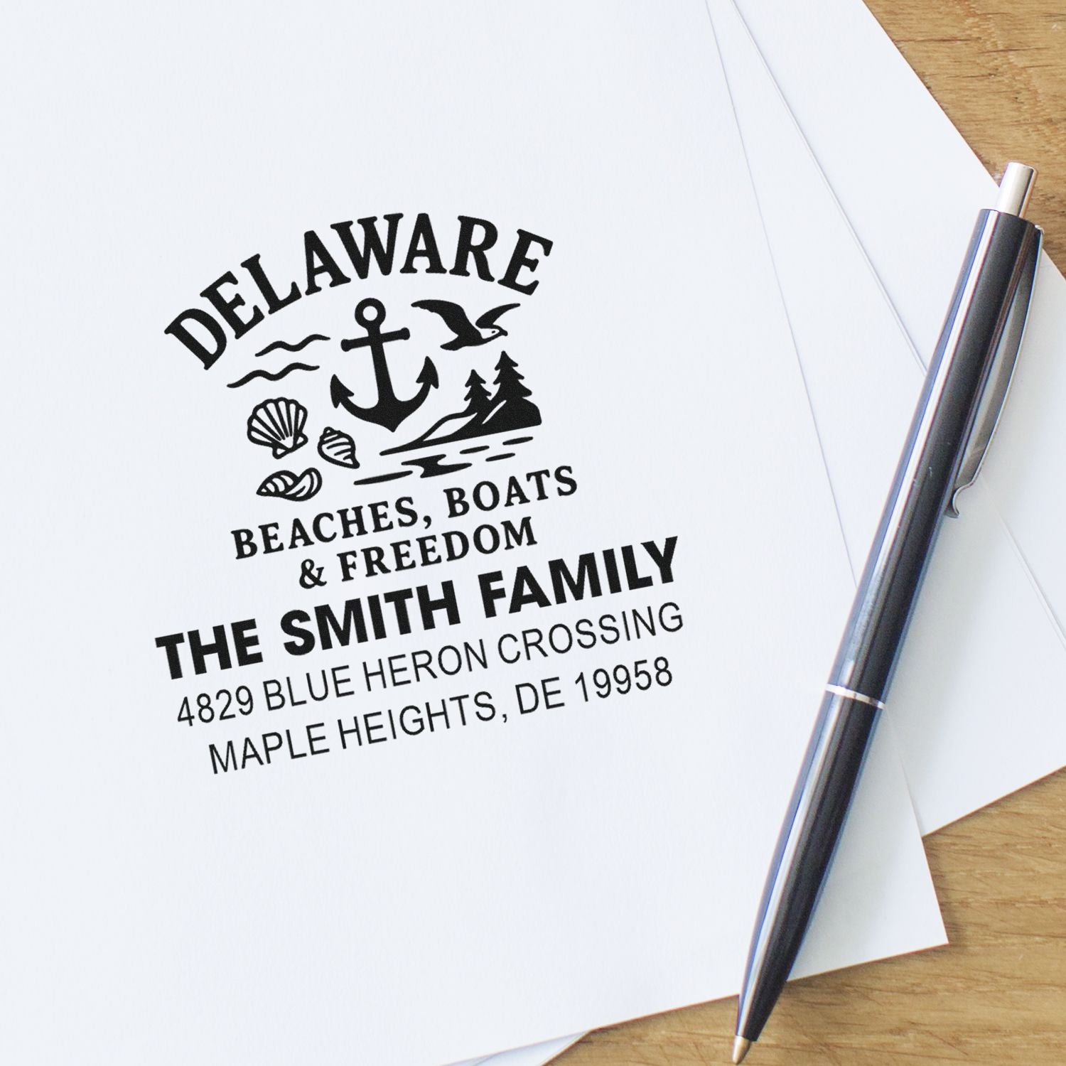 Custom rubber stamp impression for a Delaware family address, featuring a beach-themed anchor, shells and seagull design.