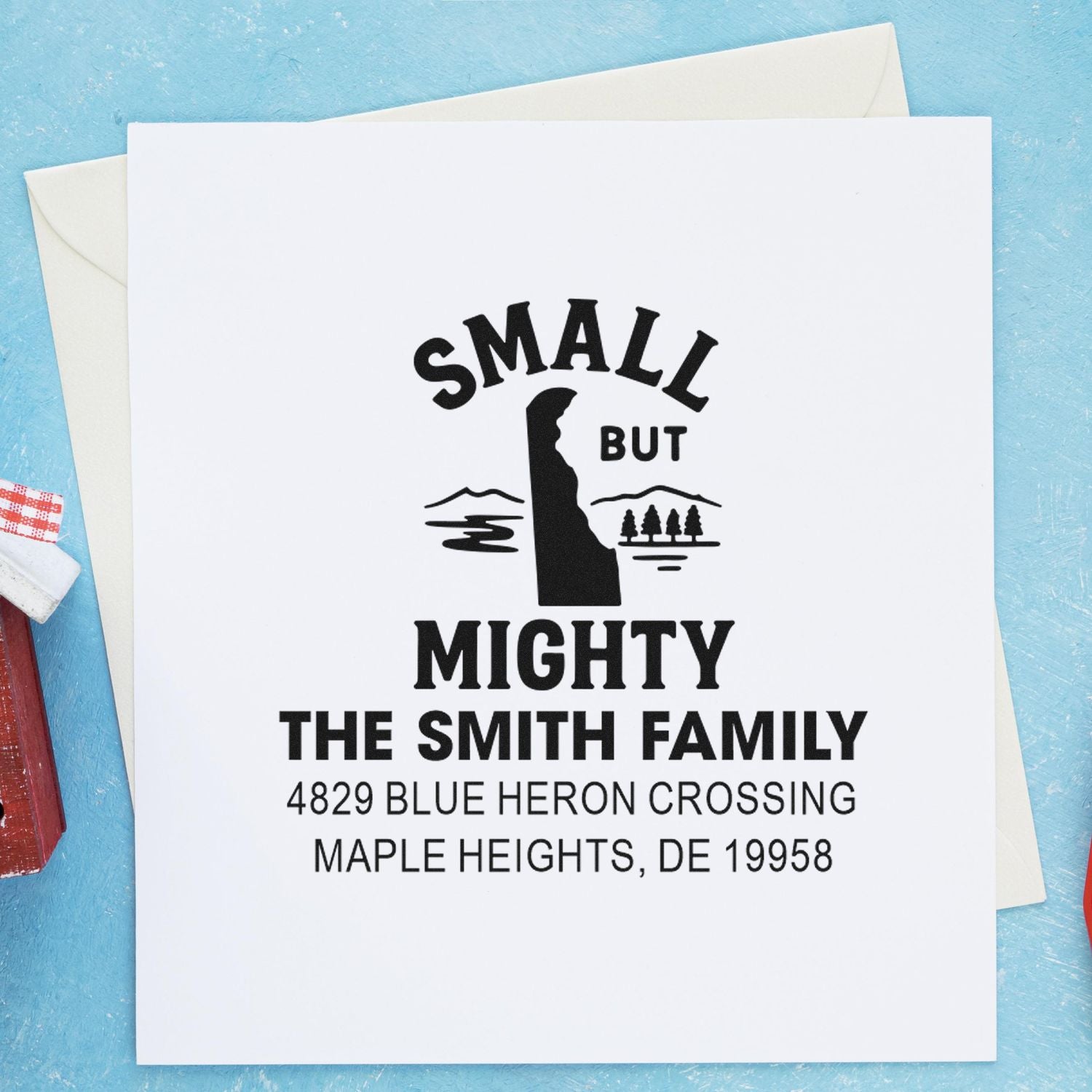 Custom return address rubber stamp on greeting card, featuring the "Small But Mighty" Smith family design and address.