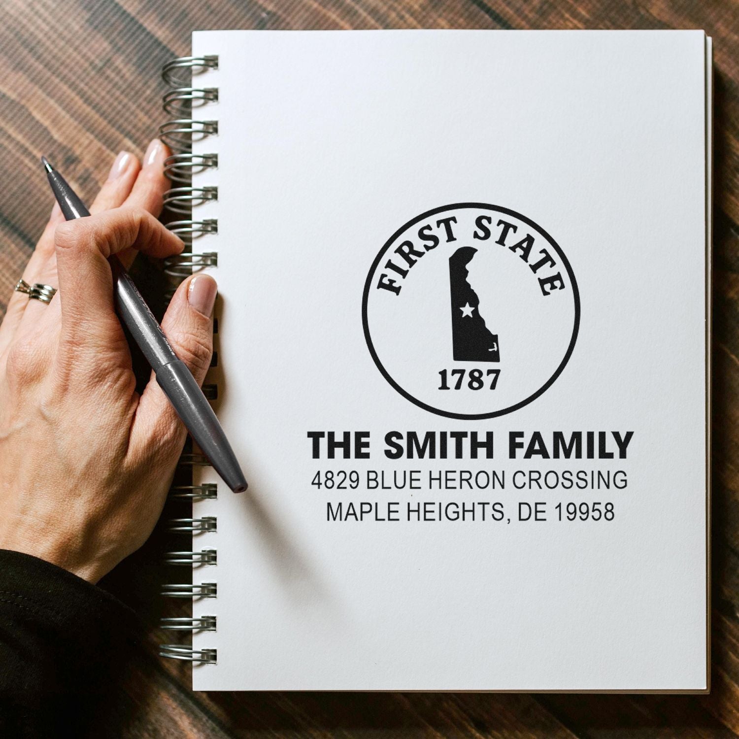 Custom rubber address stamp for The Smith Family with Delaware First State design and return address.