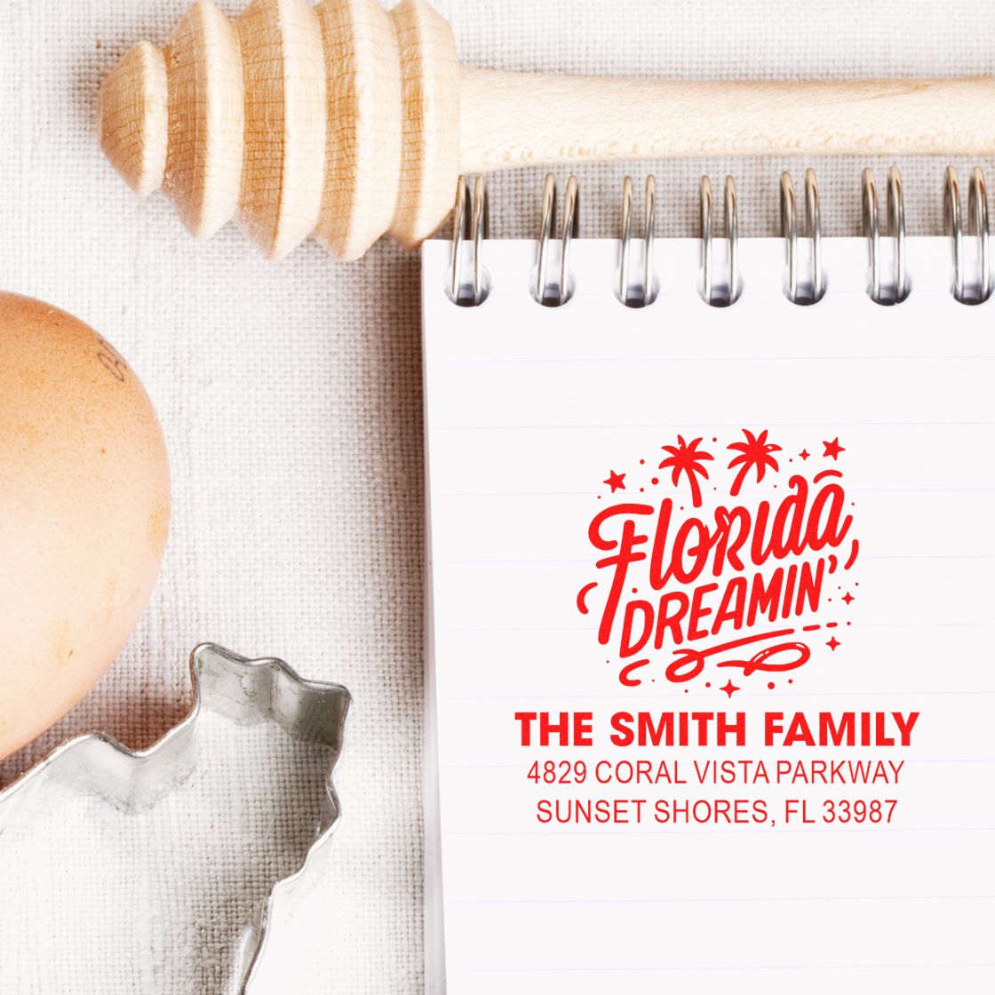 Custom Florida Dreamin' return address rubber stamp design with family name and address on a notebook, styled with kitchen decor.