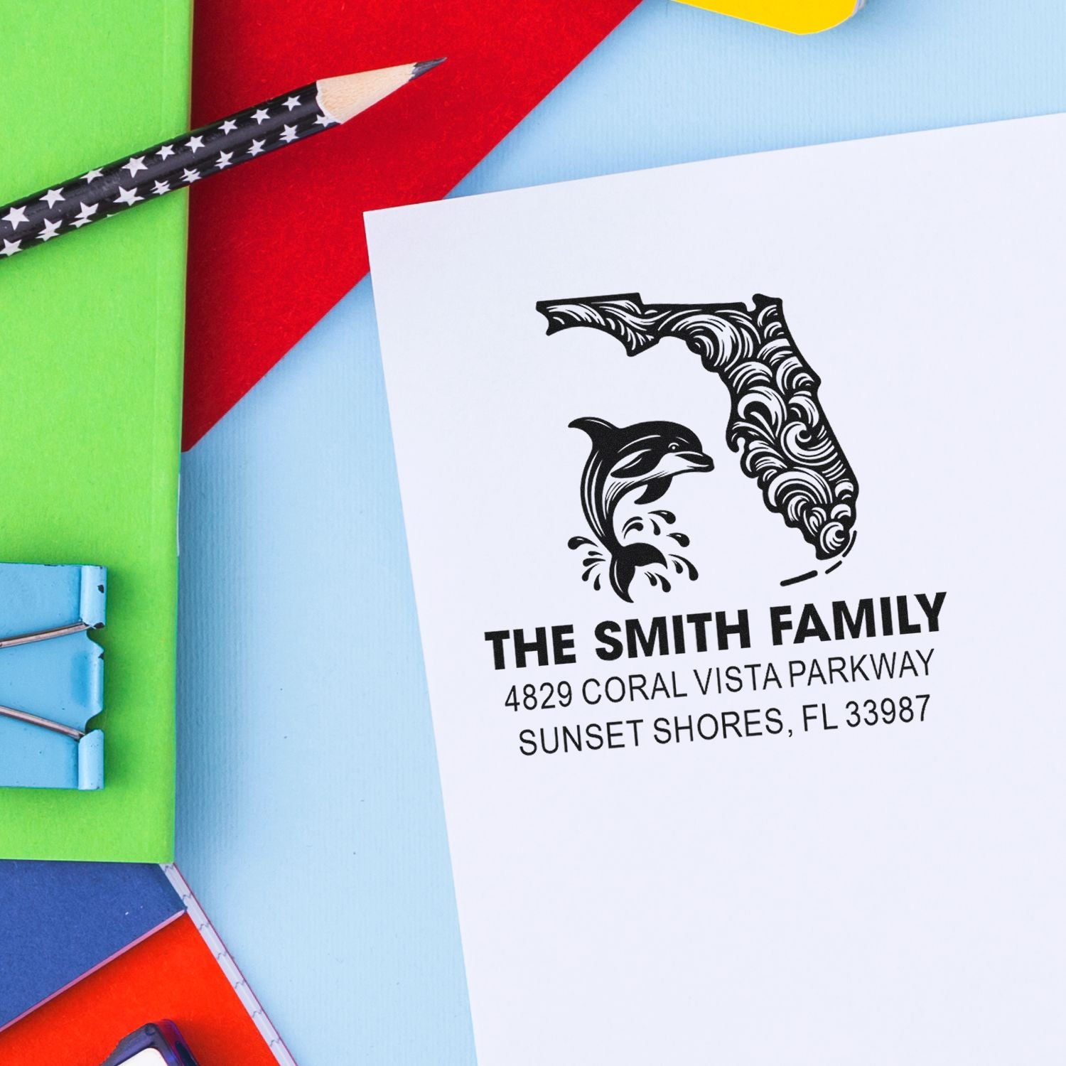 Custom return address rubber stamp with Florida dolphin design on stationery, featuring The Smith Family sample imprint.