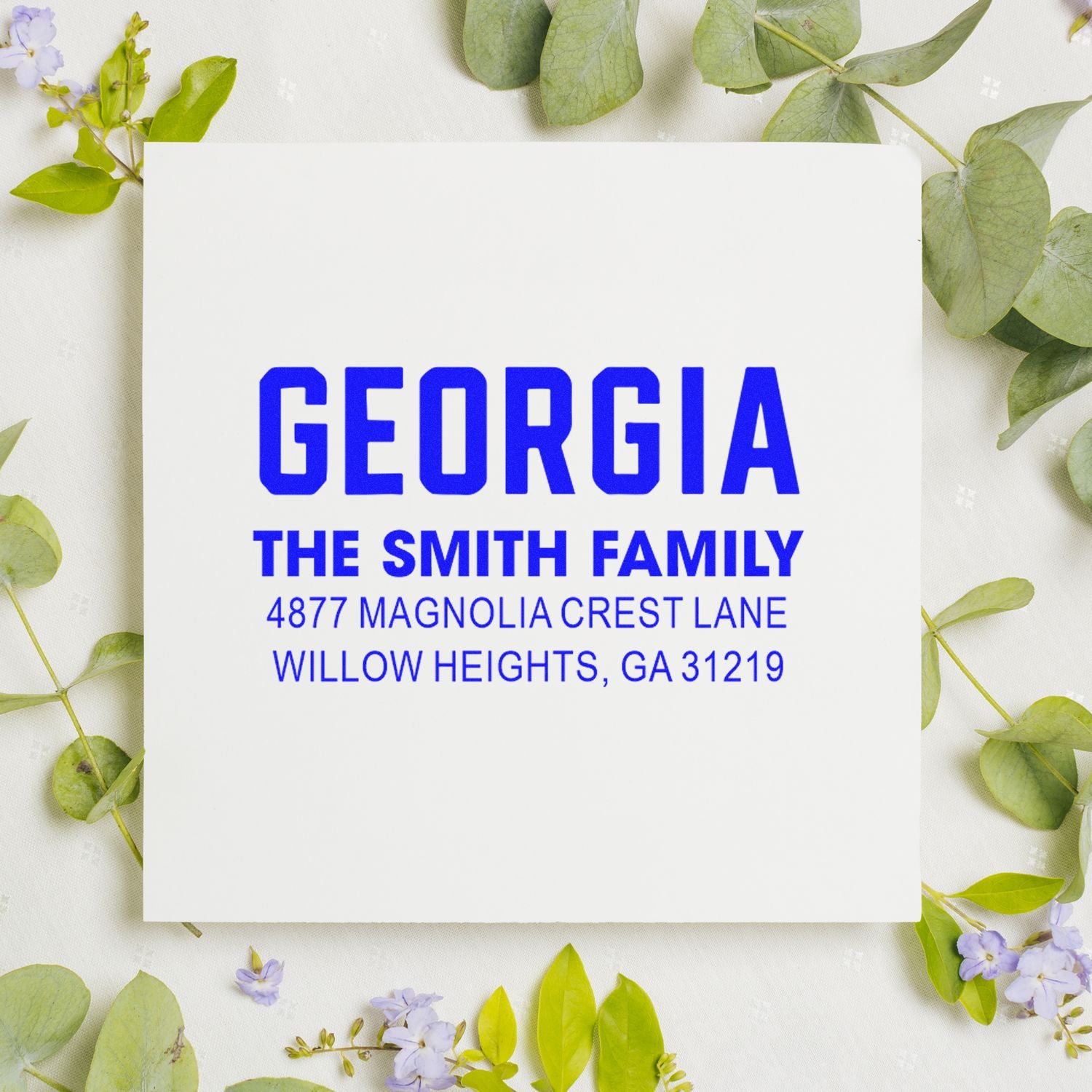 Custom return address rubber stamp for The Smith Family in Georgia, featuring name and mailing address in blue.