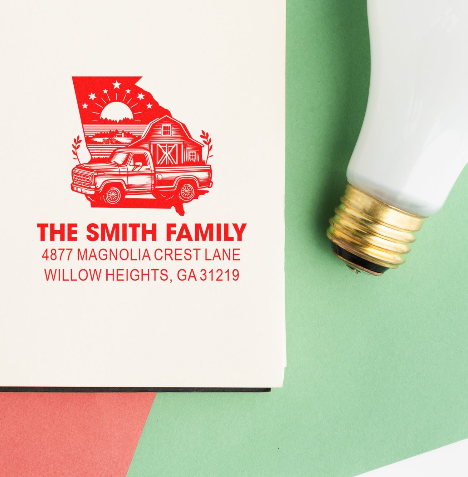Custom family return address rubber stamp with red imprint and stamp tool on paper