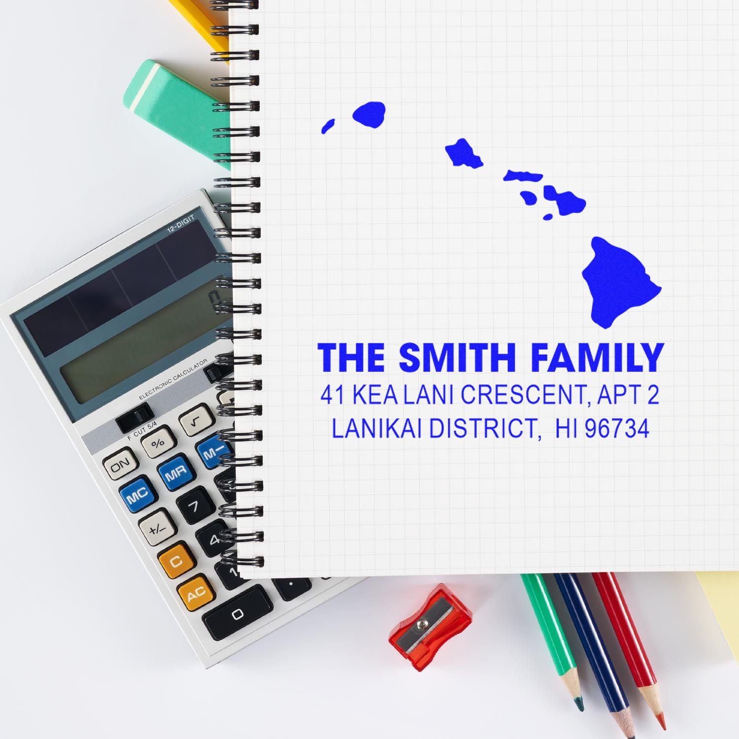 Custom return address rubber stamp on notebook, showing Hawaii map and family mailing details for stationery use.