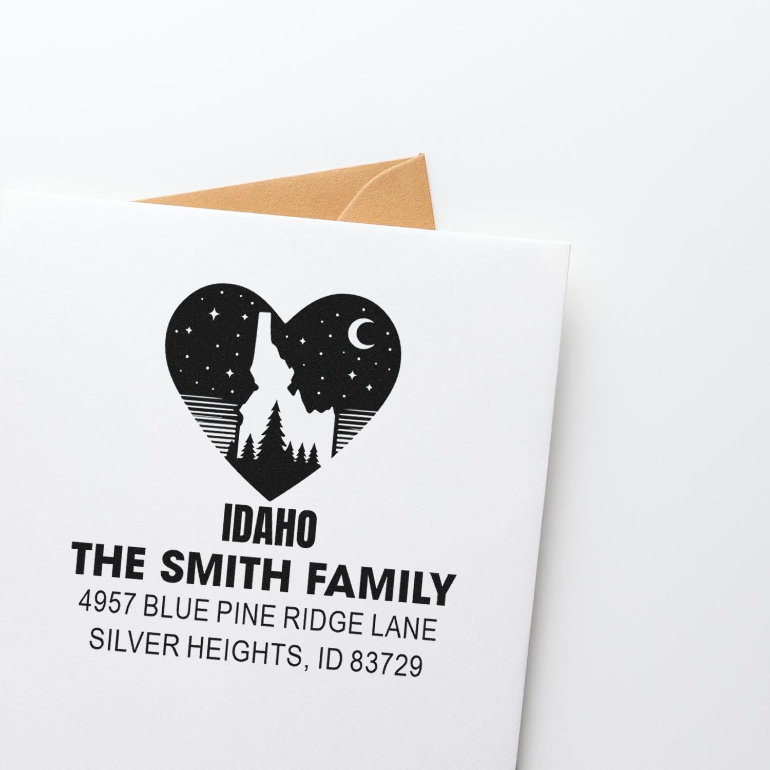 Custom Idaho family return address rubber stamp with heart-shaped mountain and pine design for envelopes and holiday cards.