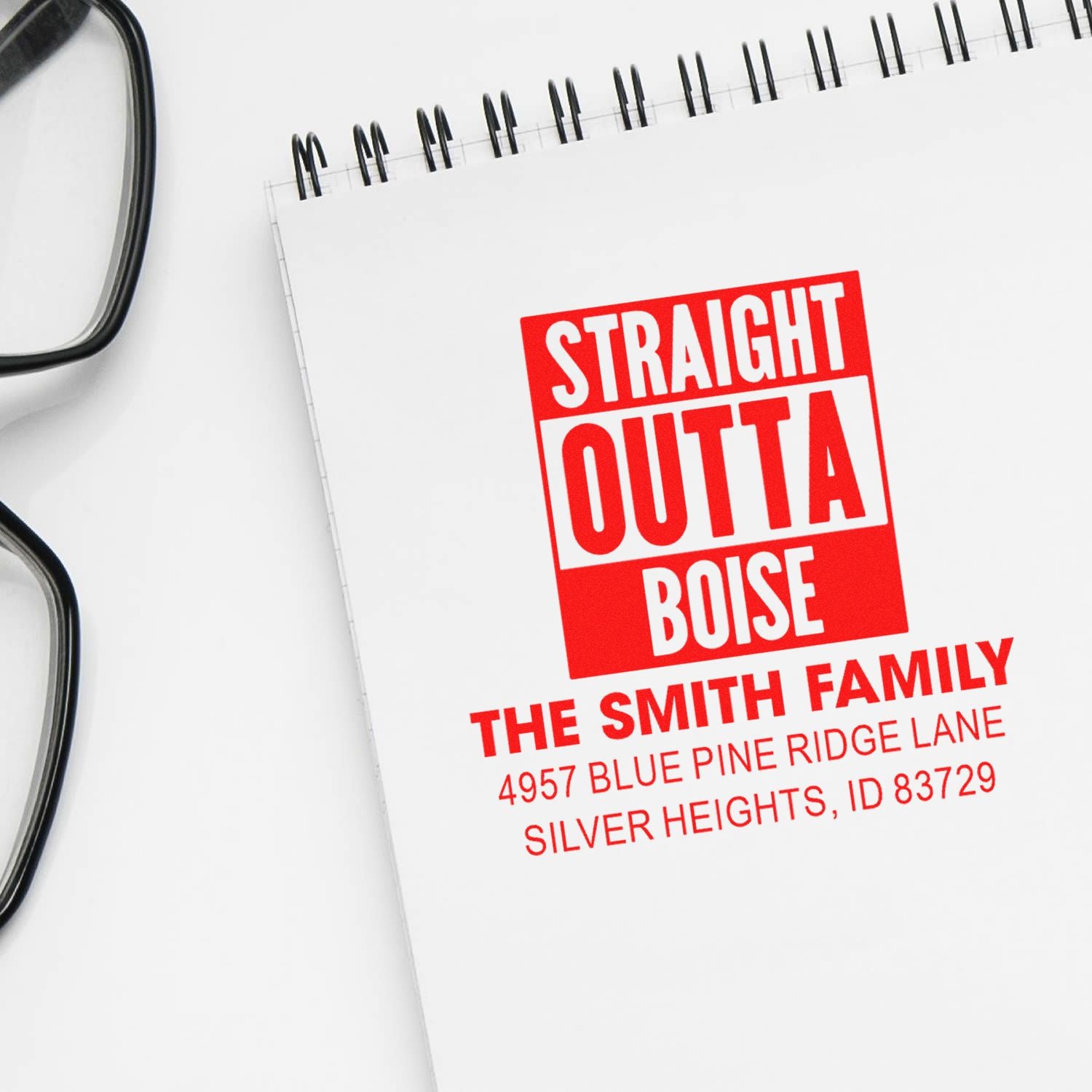Custom rubber stamp imprint reading Straight Outta Boise with The Smith Family address on a notebook, for personalized address stamping.