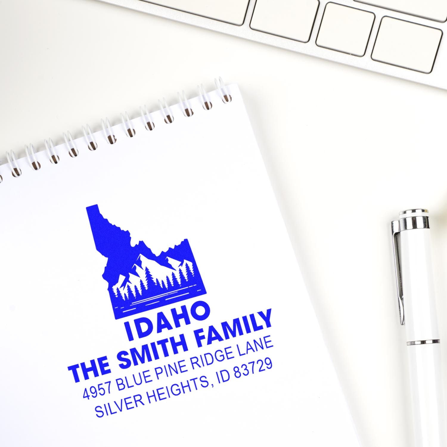 Custom Idaho family address rubber stamp with mountain logo and return address on notebook