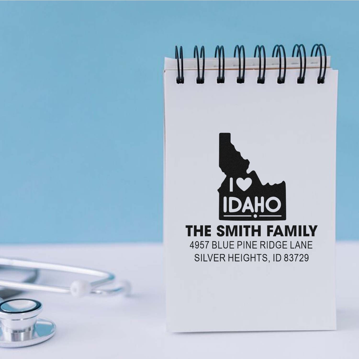 Personalized Idaho return address rubber stamp with family name and mailing address on a notepad for custom mailings.