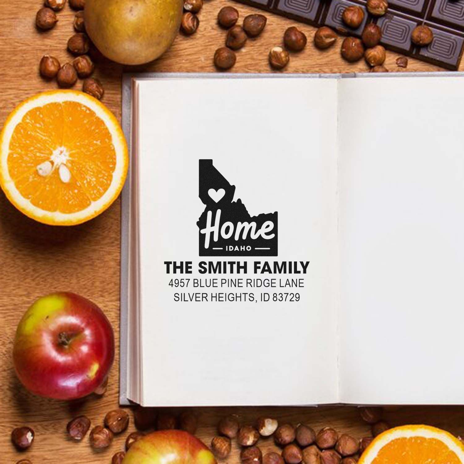 Custom Idaho home return address rubber stamp for The Smith Family, shown stamped on an open notebook.