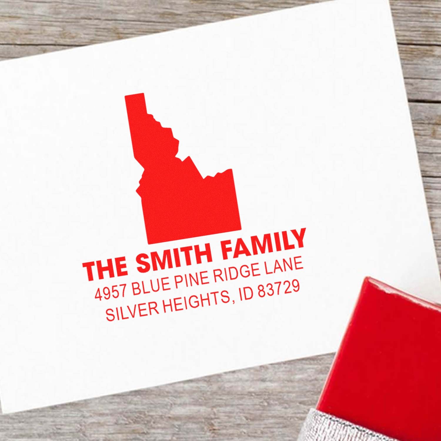 Custom Idaho return address rubber stamp for The Smith Family, featuring name, address and state silhouette in red ink.