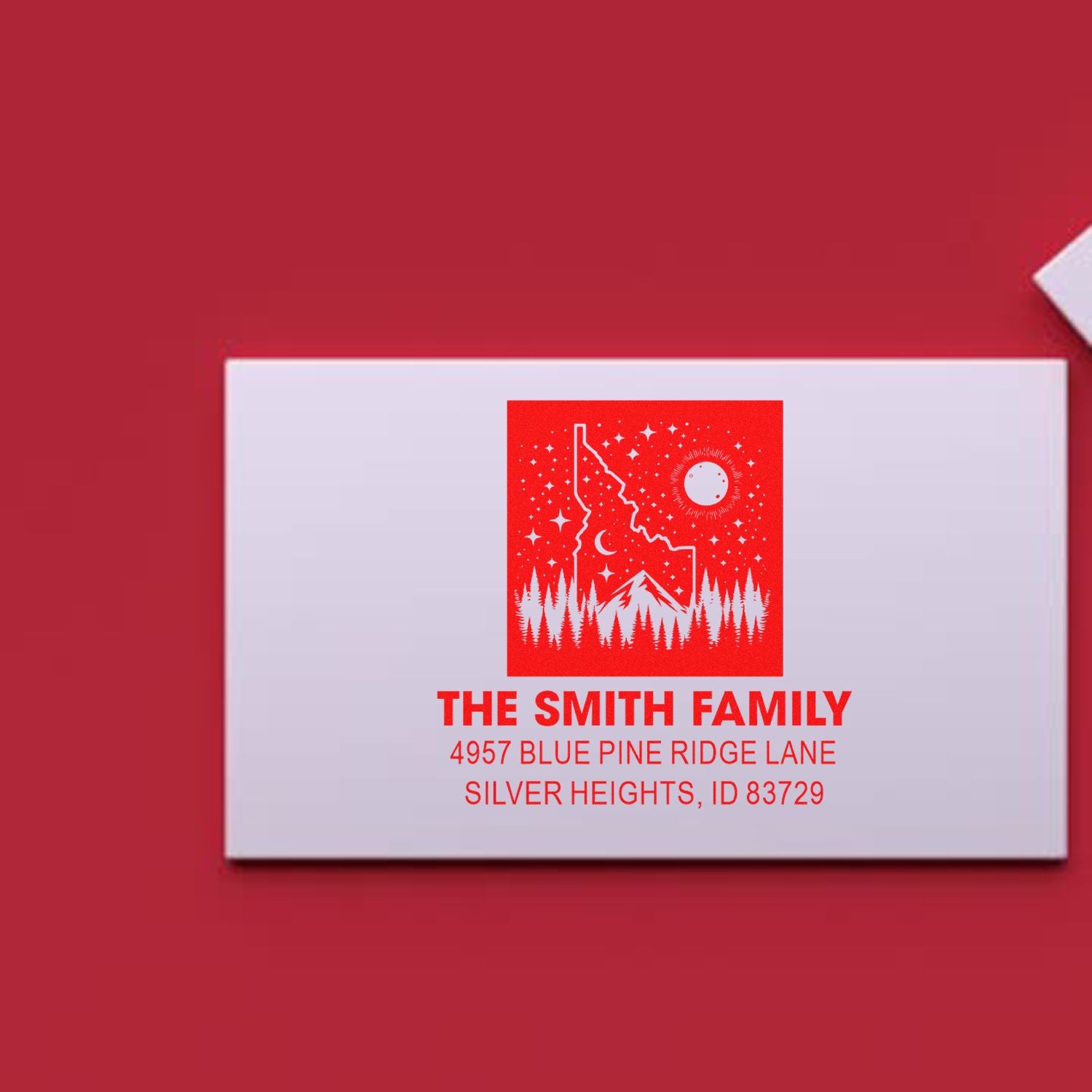 Custom family return address rubber stamp featuring mountain design and address imprint on a white envelope.