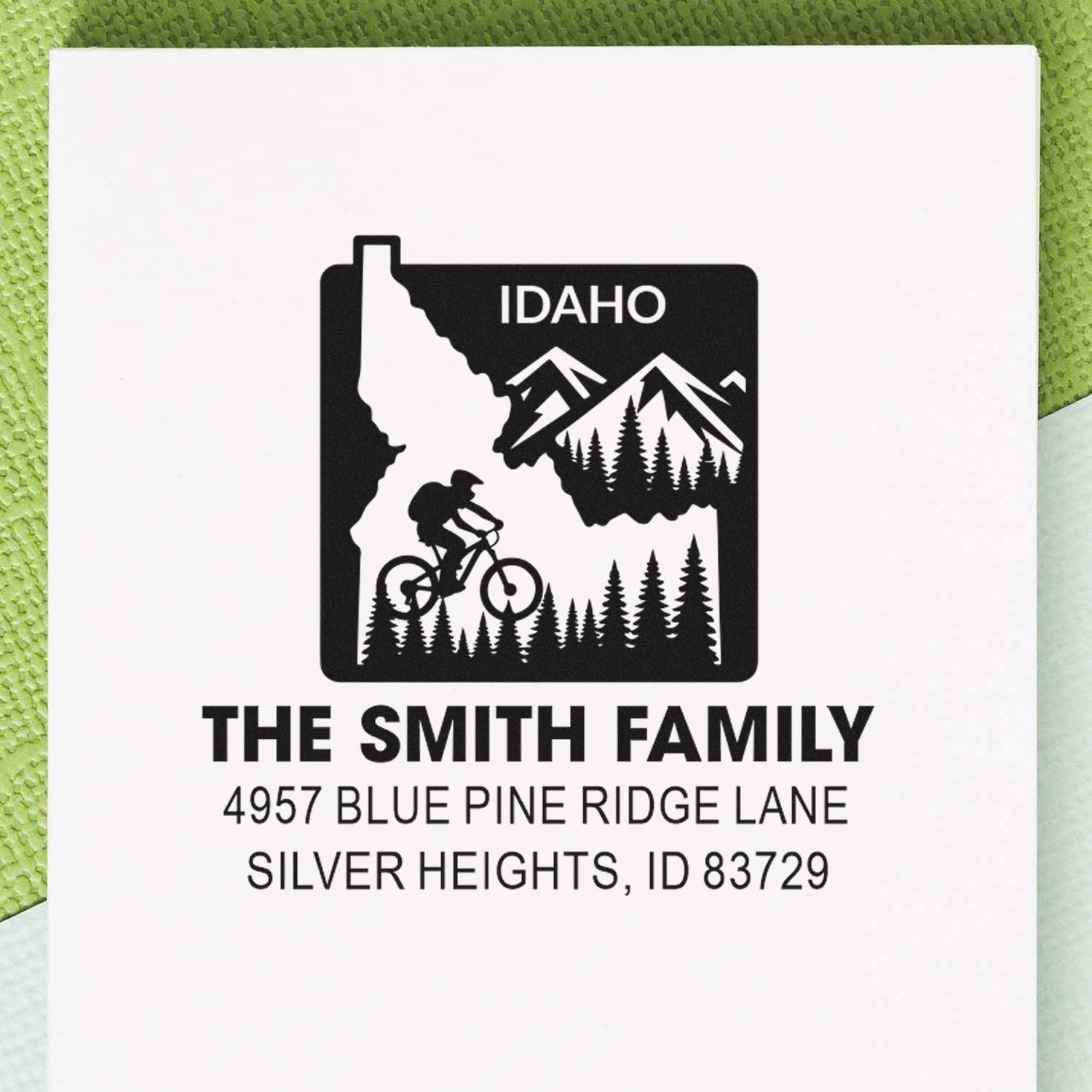 Personalized Idaho rubber stamp with mountain biker, pine trees, family name and address for custom return mail.