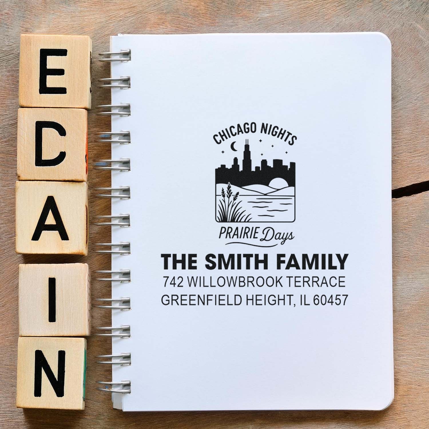Custom rubber stamp example with Chicago Nights Prairie Days logo and The Smith Family return address on a notebook.