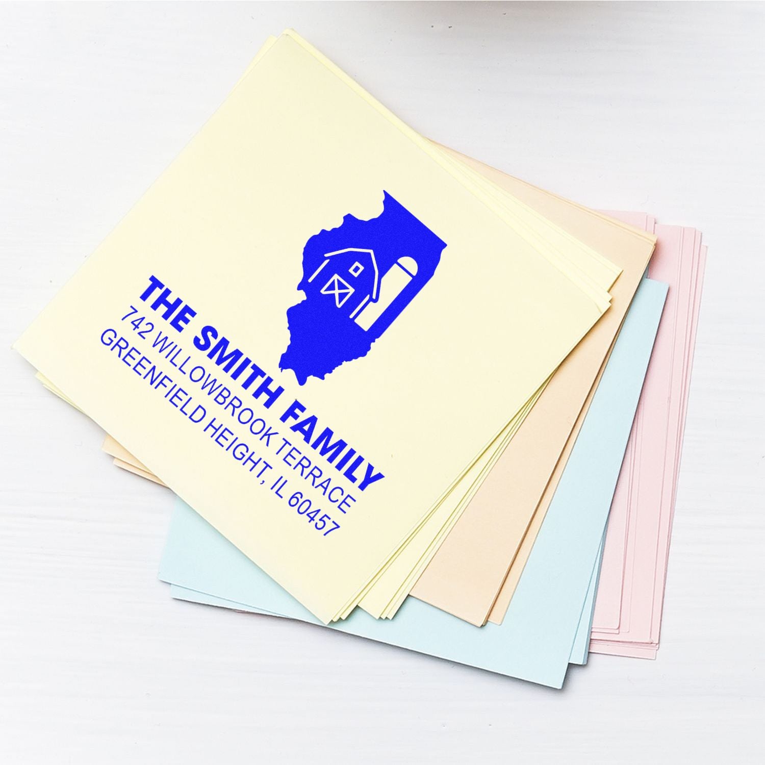 Personalized return address rubber stamp for The Smith Family on pastel file folders.