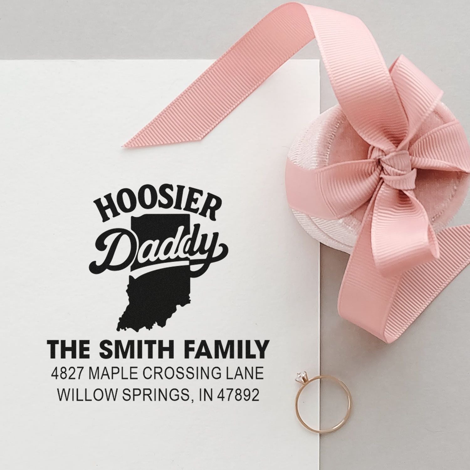 Custom address rubber stamp with Hoosier Daddy Indiana design for The Smith Family, styled as a gift with pink ribbon.