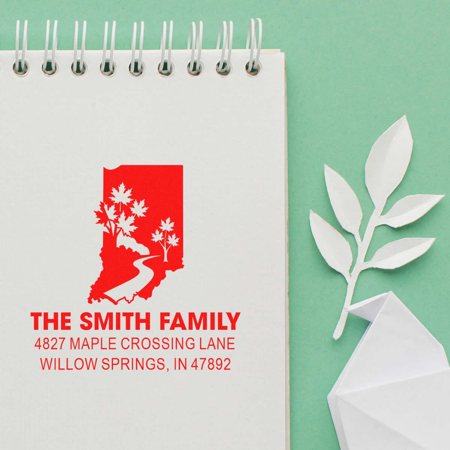 Custom return address rubber stamp with Indiana design, The Smith Family name and address on a notebook page.