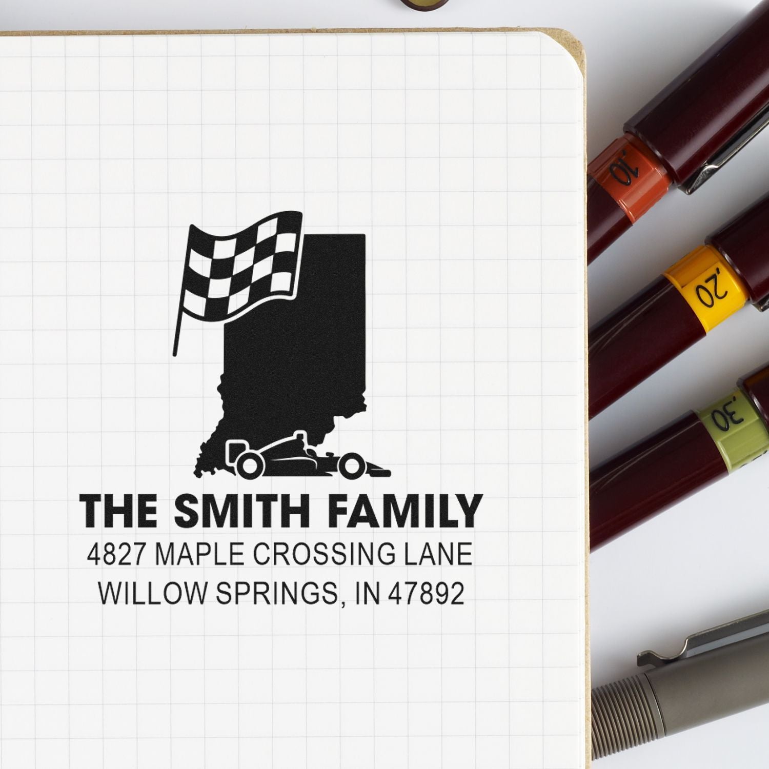 Custom Indiana address rubber stamp with race car and checkered flag design for The Smith Family, 4827 Maple Crossing Lane.
