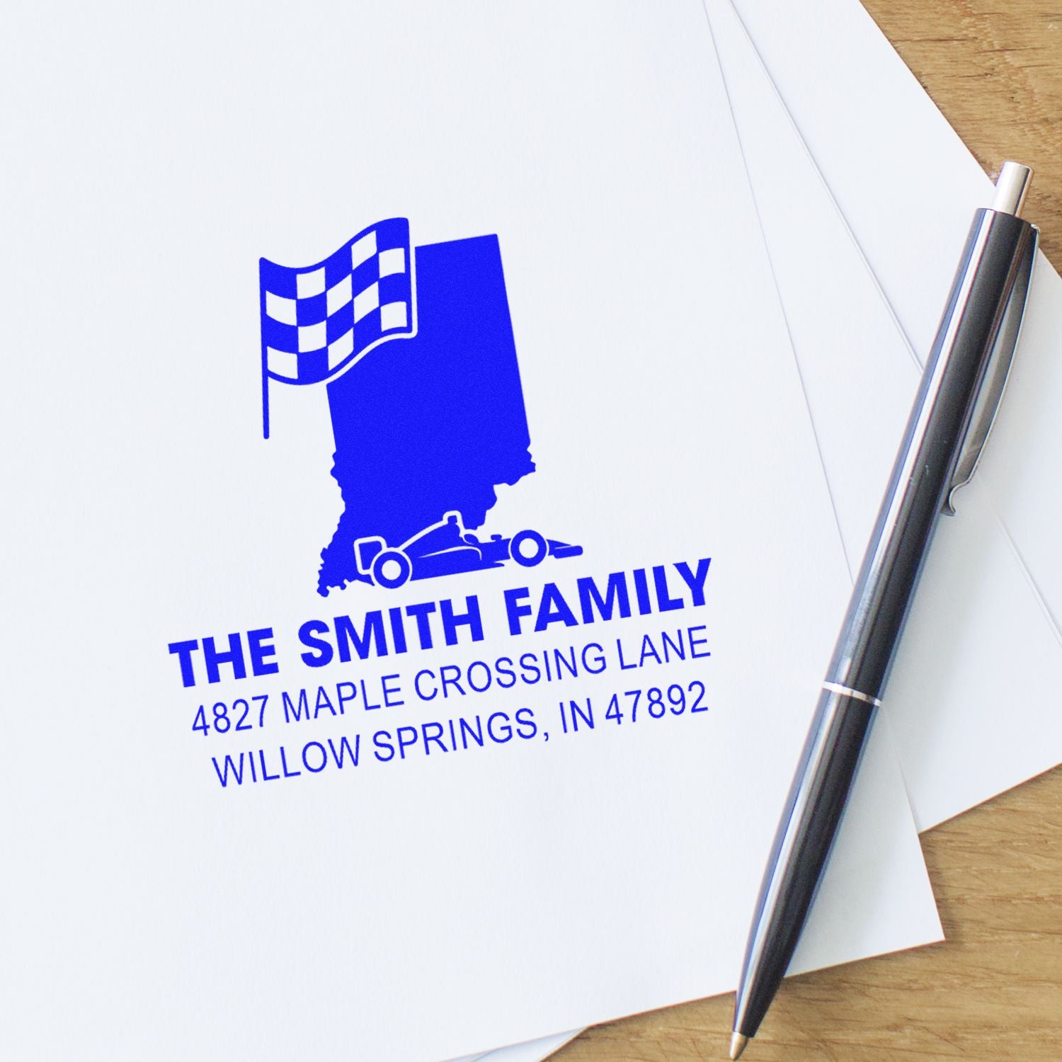 Custom family return address rubber stamp with Indiana race car design and checkered flag for personalized mailing.
