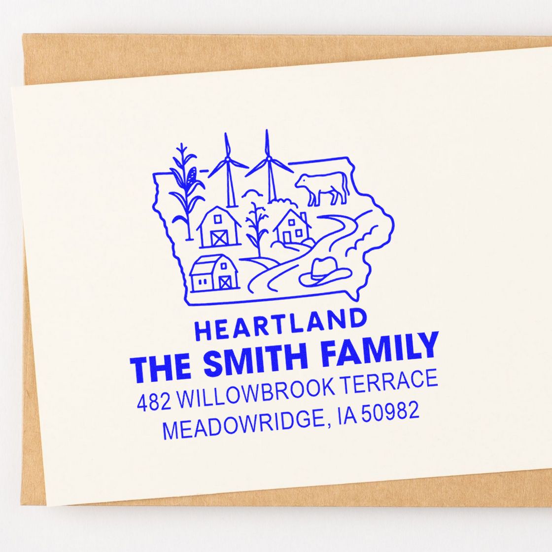 Blue custom return address rubber stamp for The Smith Family with Heartland farm logo and Meadowridge, IA address.