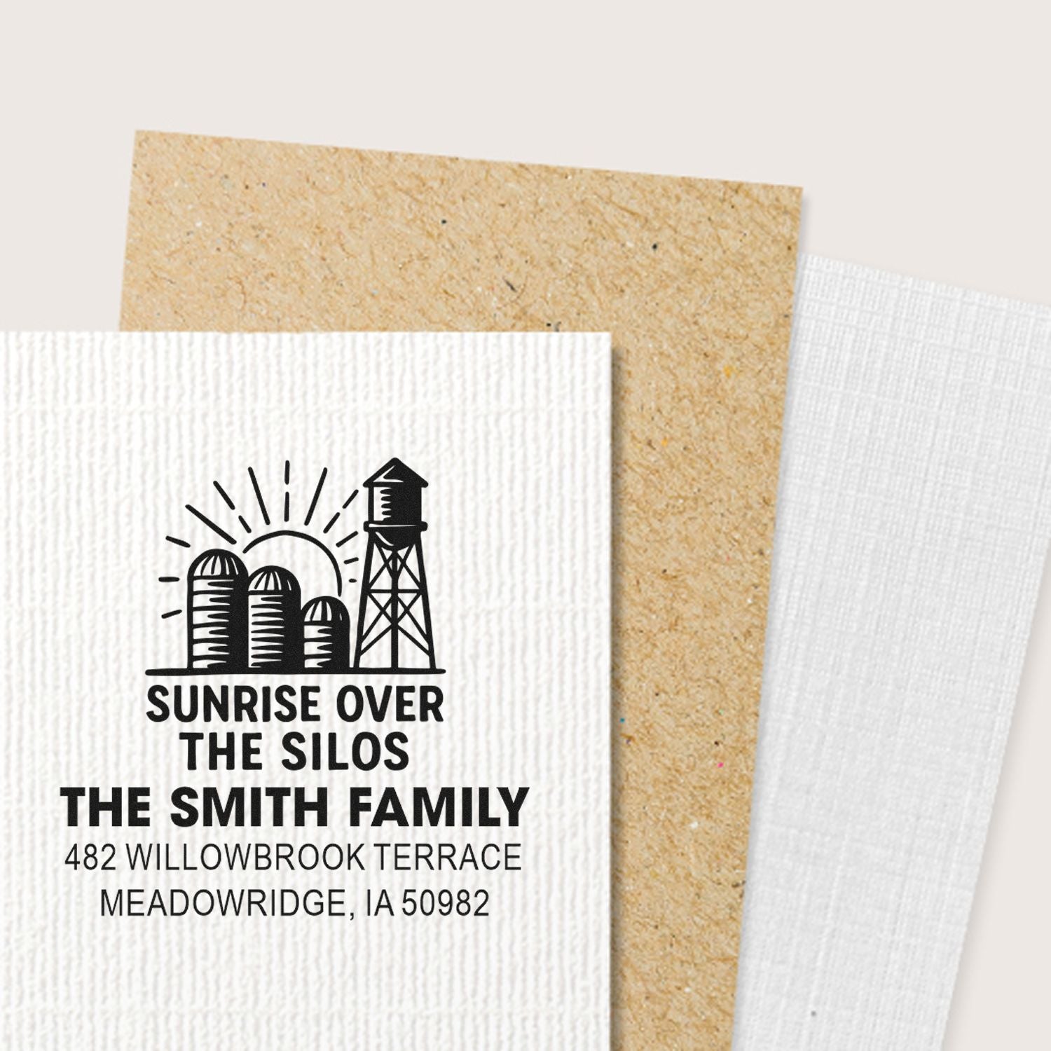 Custom farm address rubber stamp with sunrise over silos, family name, and mailing address for rustic stationery.