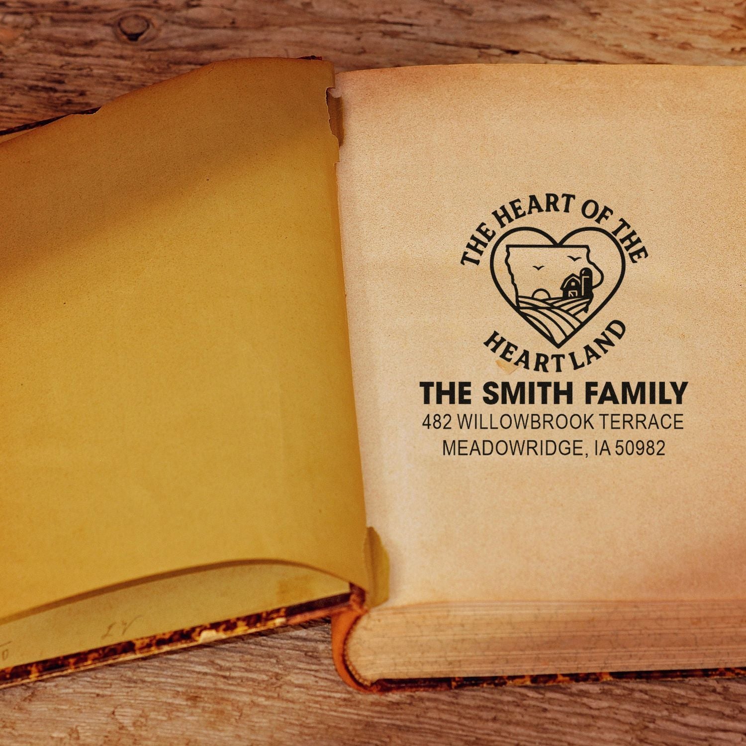 Custom family address rubber stamp on an open book, featuring The Smith Family Heart of the Heartland design.
