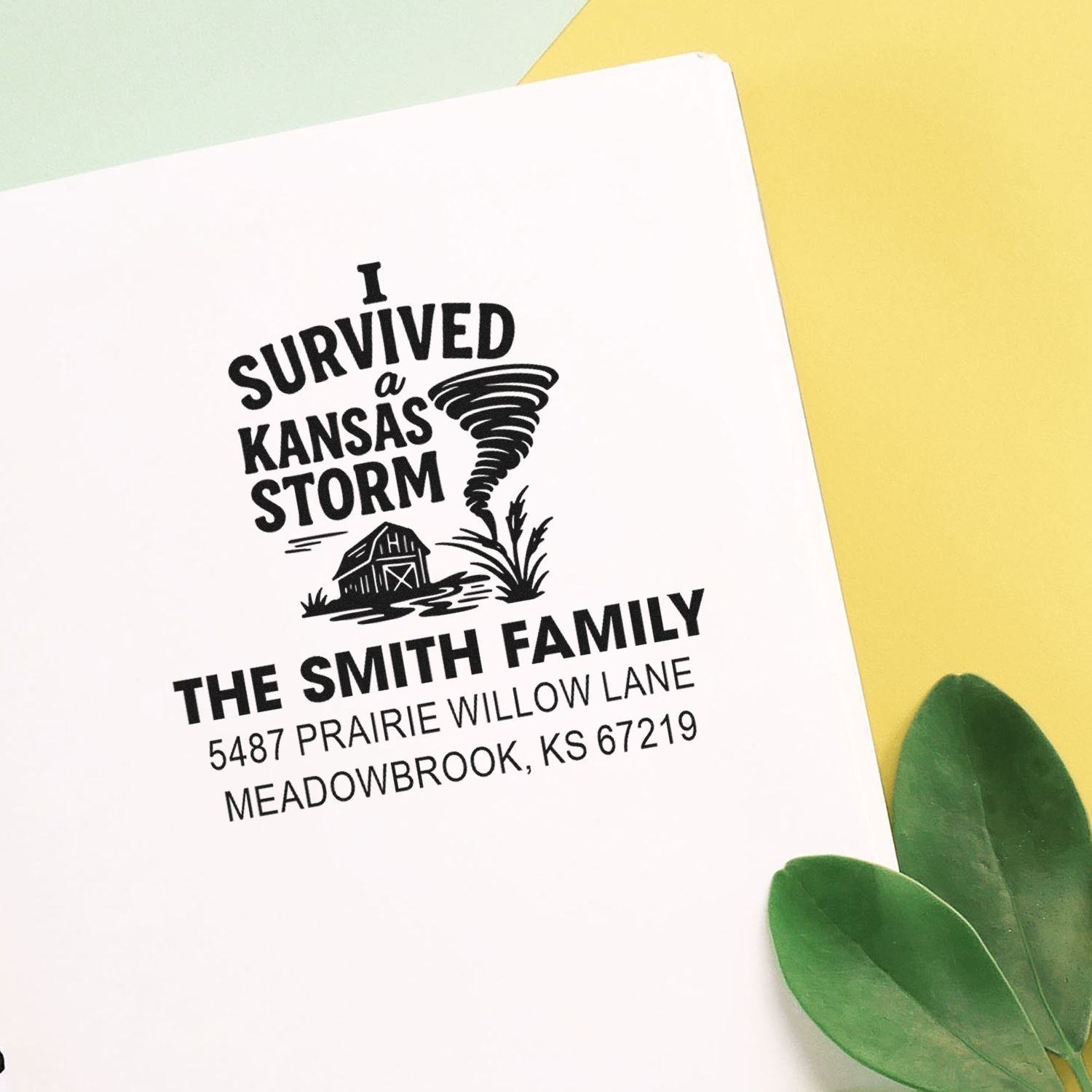 Custom rubber stamp impression reading I Survived a Kansas Storm with family name and address for personalized mail.