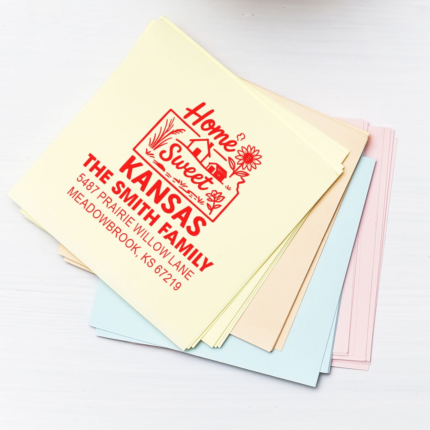 Custom family return address rubber stamp on pastel stationery, featuring Home Sweet Kansas design for personalized mailings.