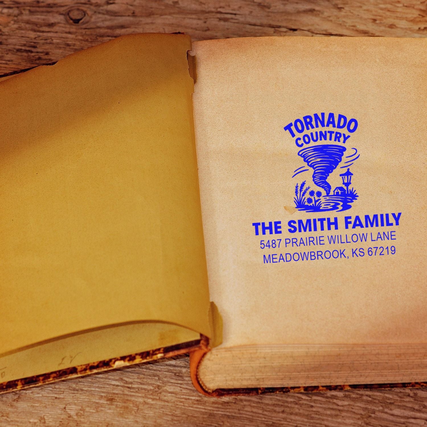 Custom address rubber stamp imprint with tornado design for The Smith Family on an open book page.