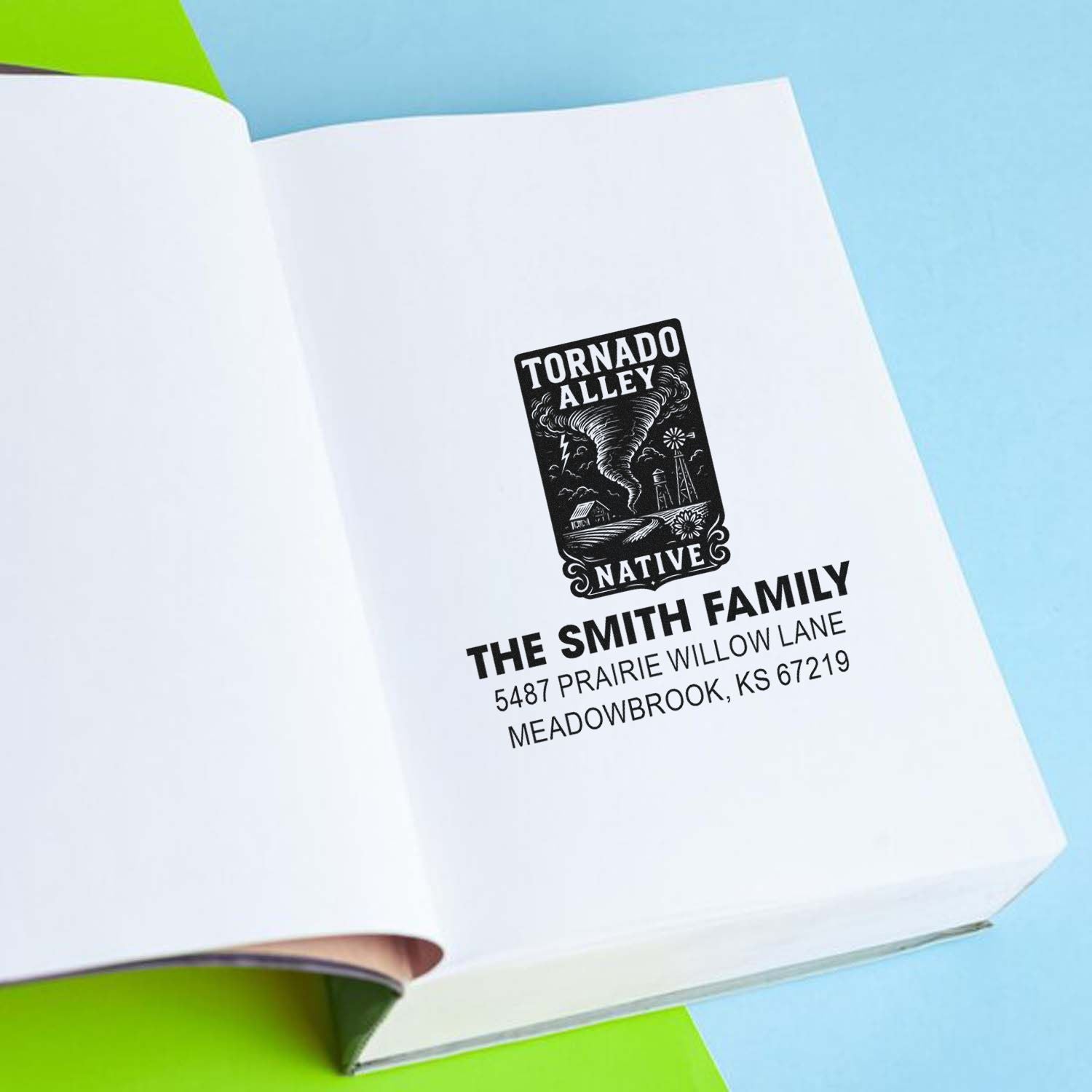 Custom rubber address stamp with Tornado Alley Native design and The Smith Family return address on a notebook page.