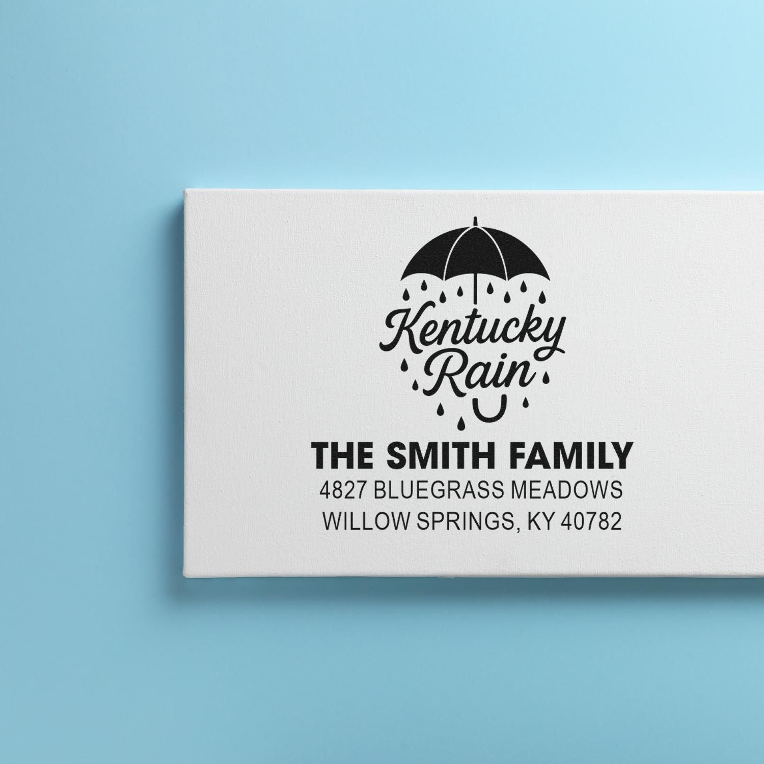 Personalized rubber address stamp with Kentucky Rain umbrella logo for The Smith Family in Willow Springs, KY.