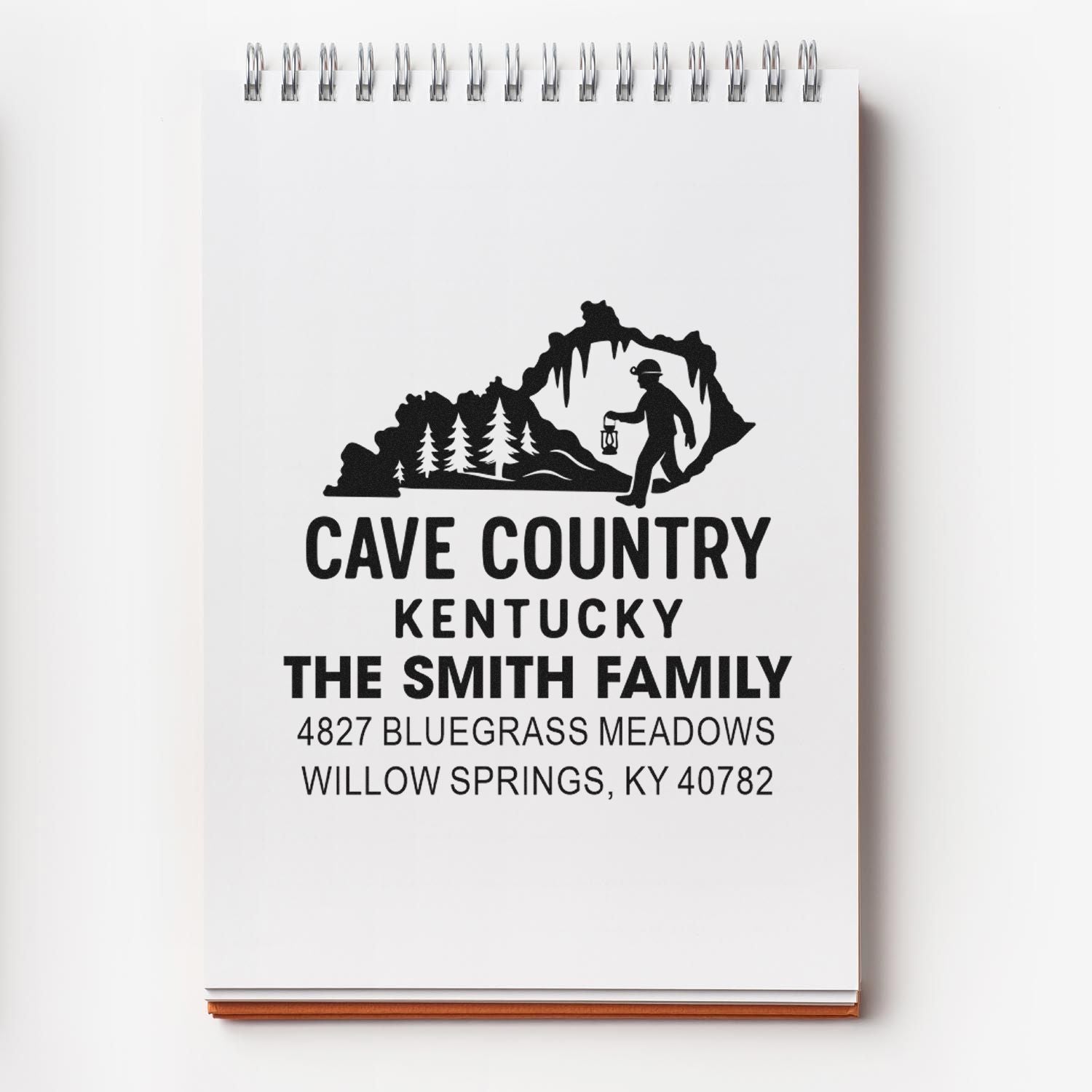 Custom rubber address stamp with Cave Country Kentucky design for The Smith Family, featuring cave explorer graphic and mailing address.