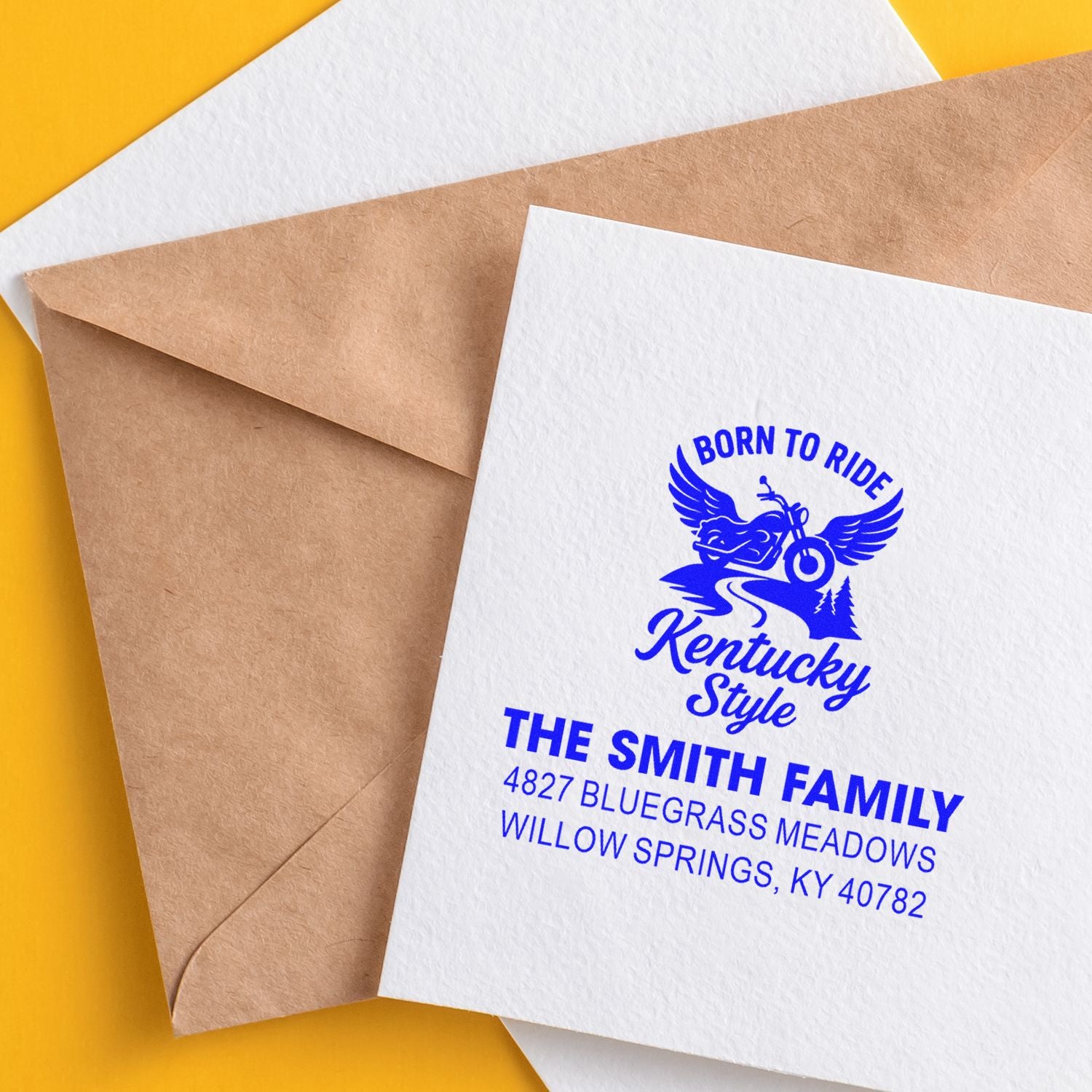 Custom rubber stamp on envelopes featuring a motorcycle family address design in blue ink for personalized mail branding.