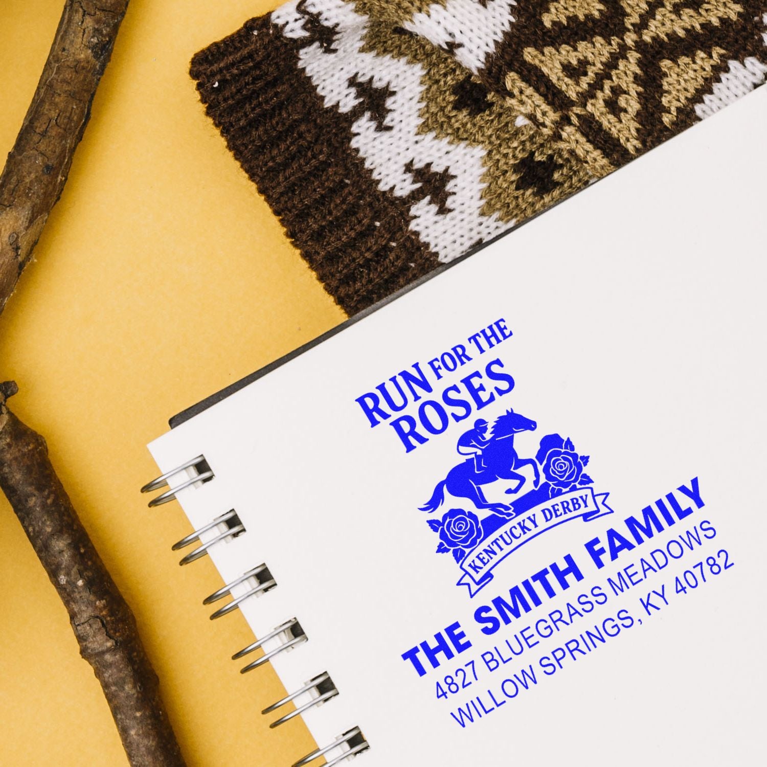 Custom Kentucky Derby address rubber stamp in blue ink on notebook