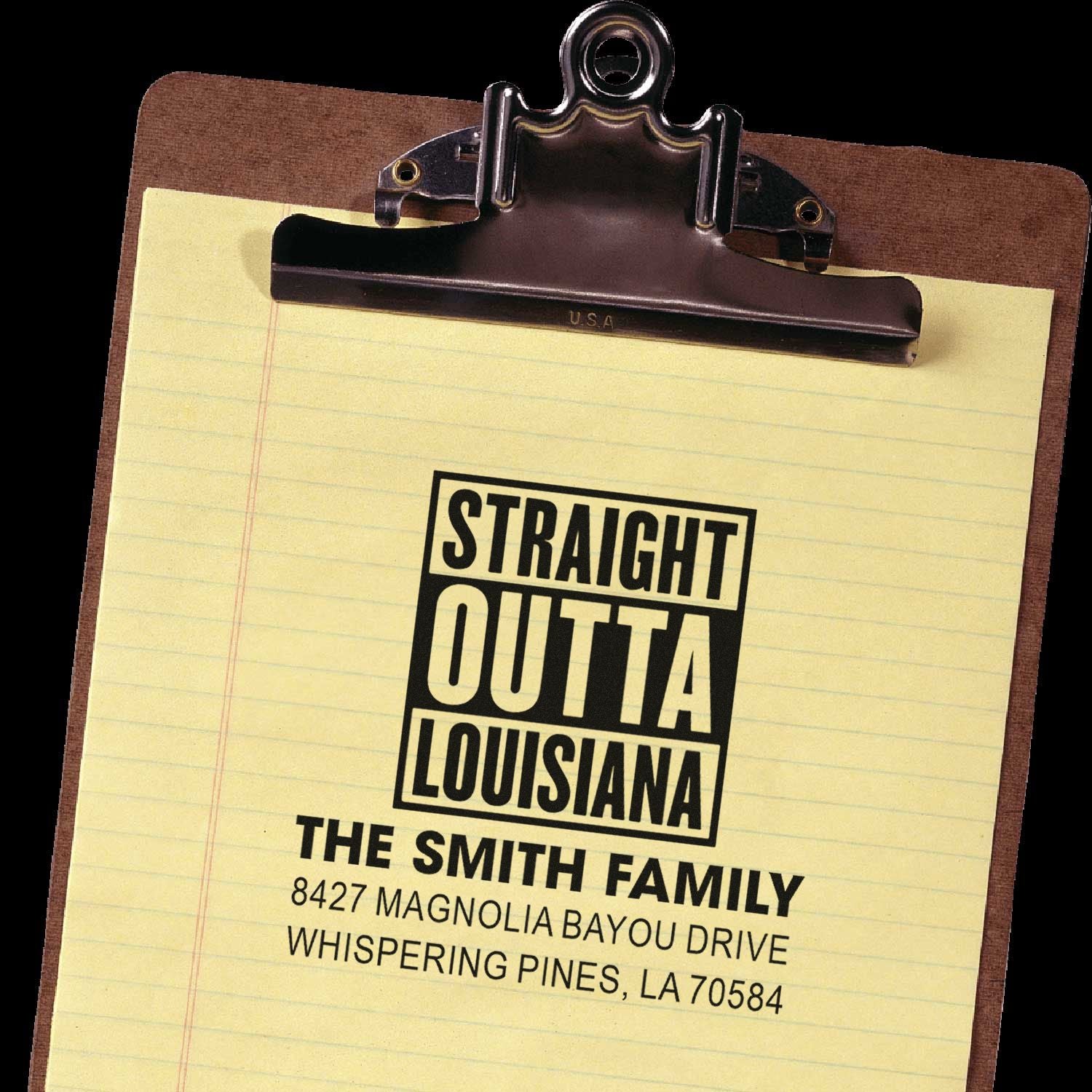 Custom rubber stamp imprint on clipboard reading Straight Outta Louisiana with family name and address.