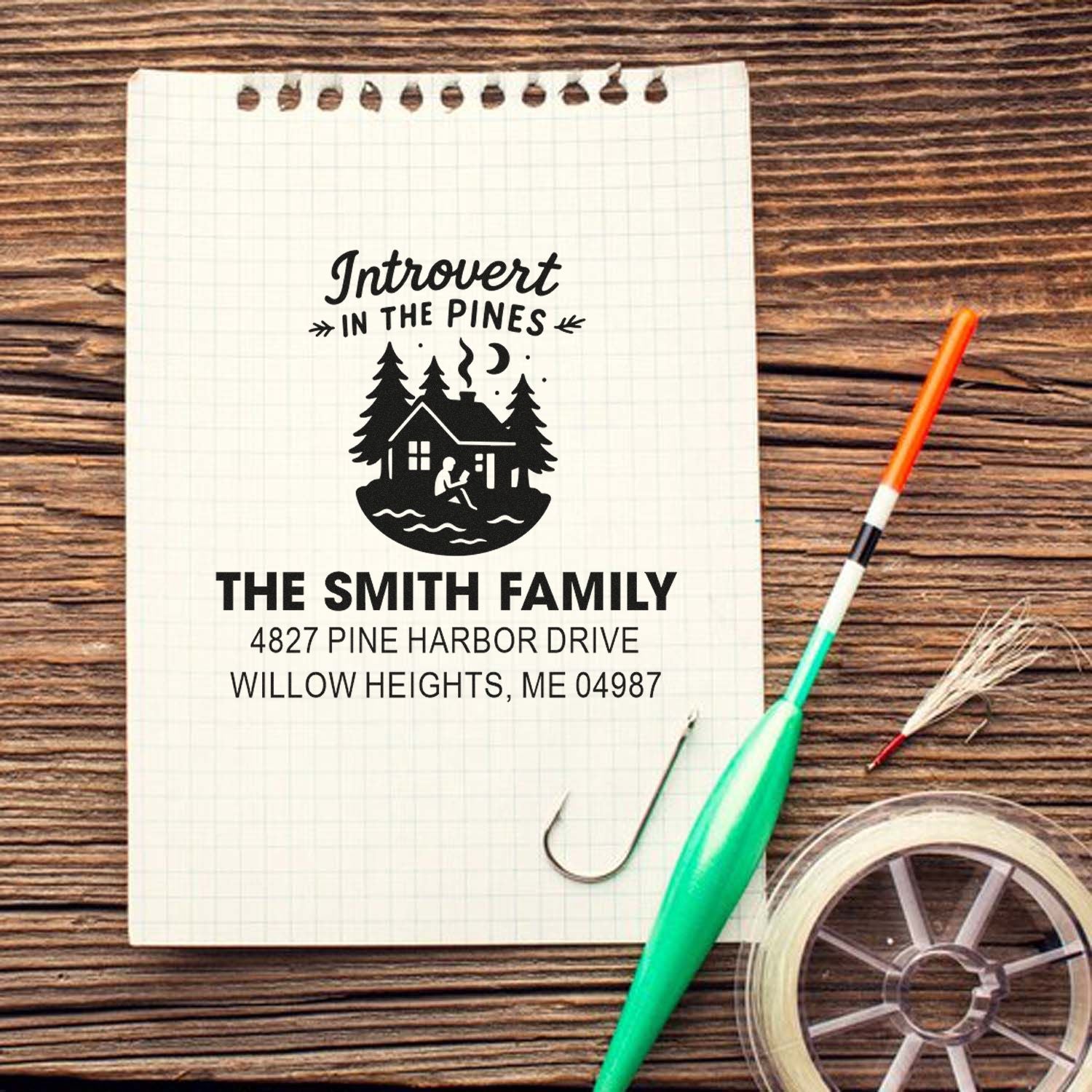Custom rubber stamp design for a personalized Introvert in the Pines return address stamp with cabin and pine tree artwork.
