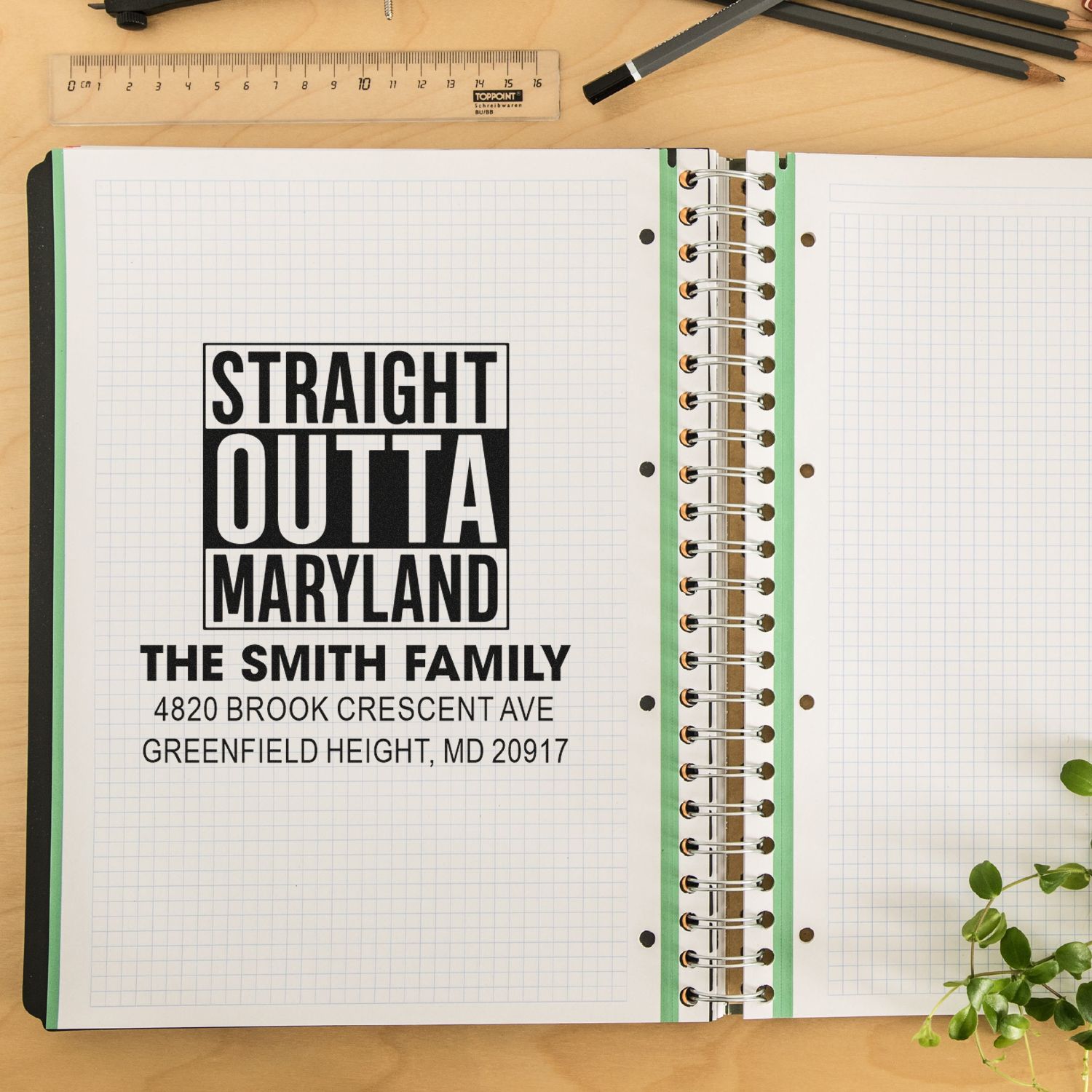 Custom address rubber stamp reading Straight Outta Maryland with family name and address on notebook paper.