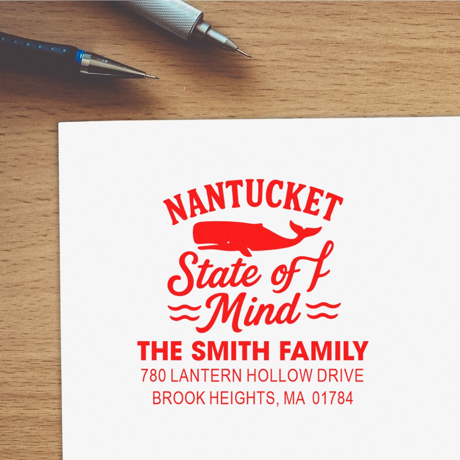 Custom rubber address stamp with Nantucket State of Mind design, family name, and return address in red ink.