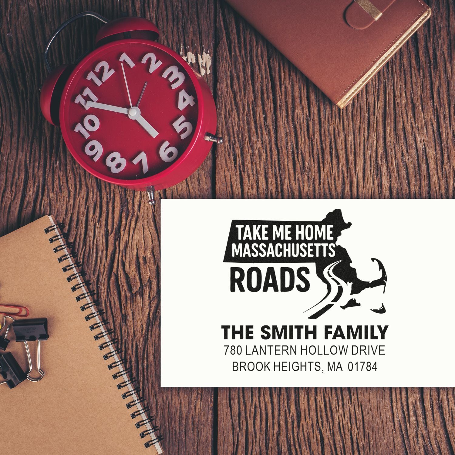 Custom Massachusetts address rubber stamp for personalized mail, featuring family name, address, and road map design.