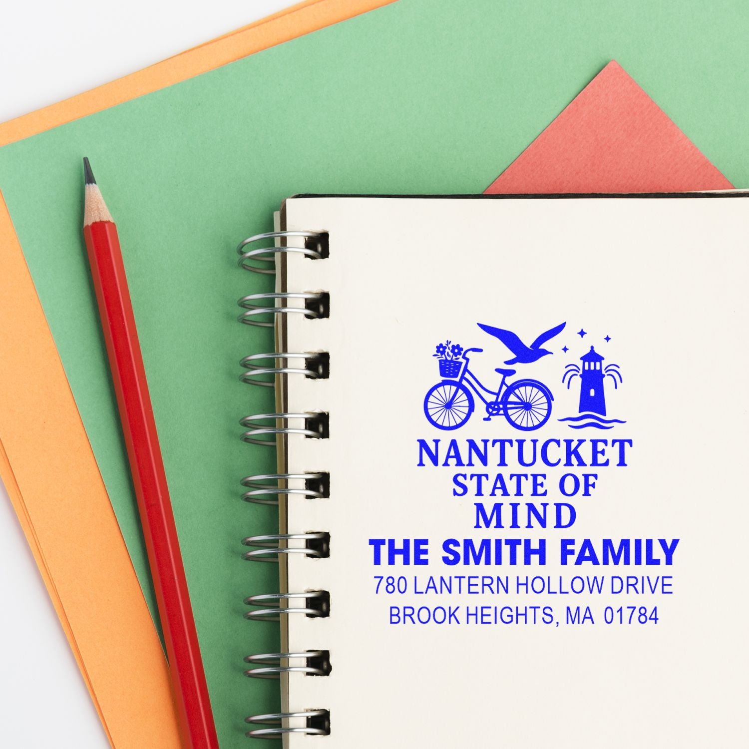 Custom Nantucket return address rubber stamp on spiral notebook, featuring family name, bike, lighthouse and address.