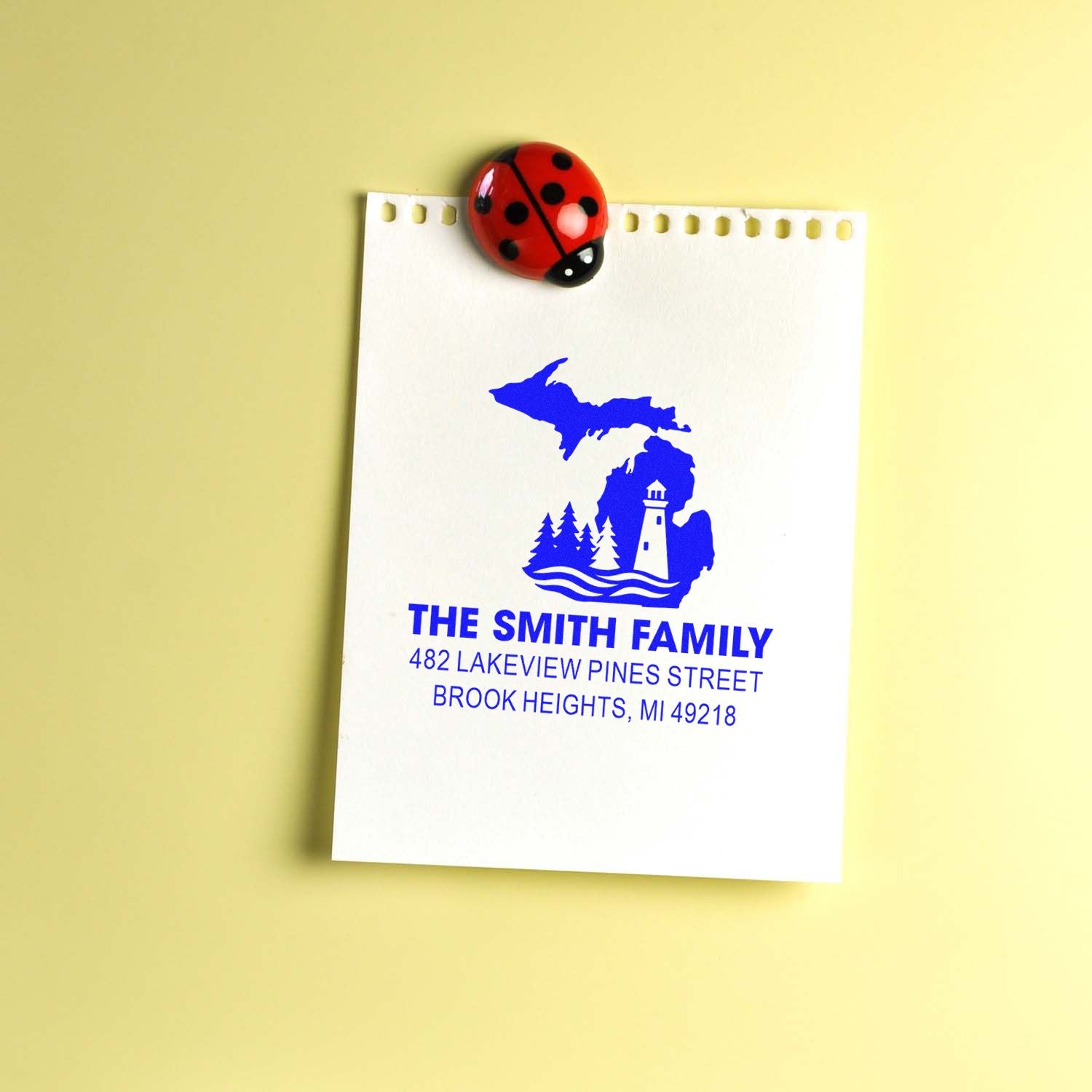 Custom return address rubber stamp with Michigan lighthouse design for The Smith Family address labeling.