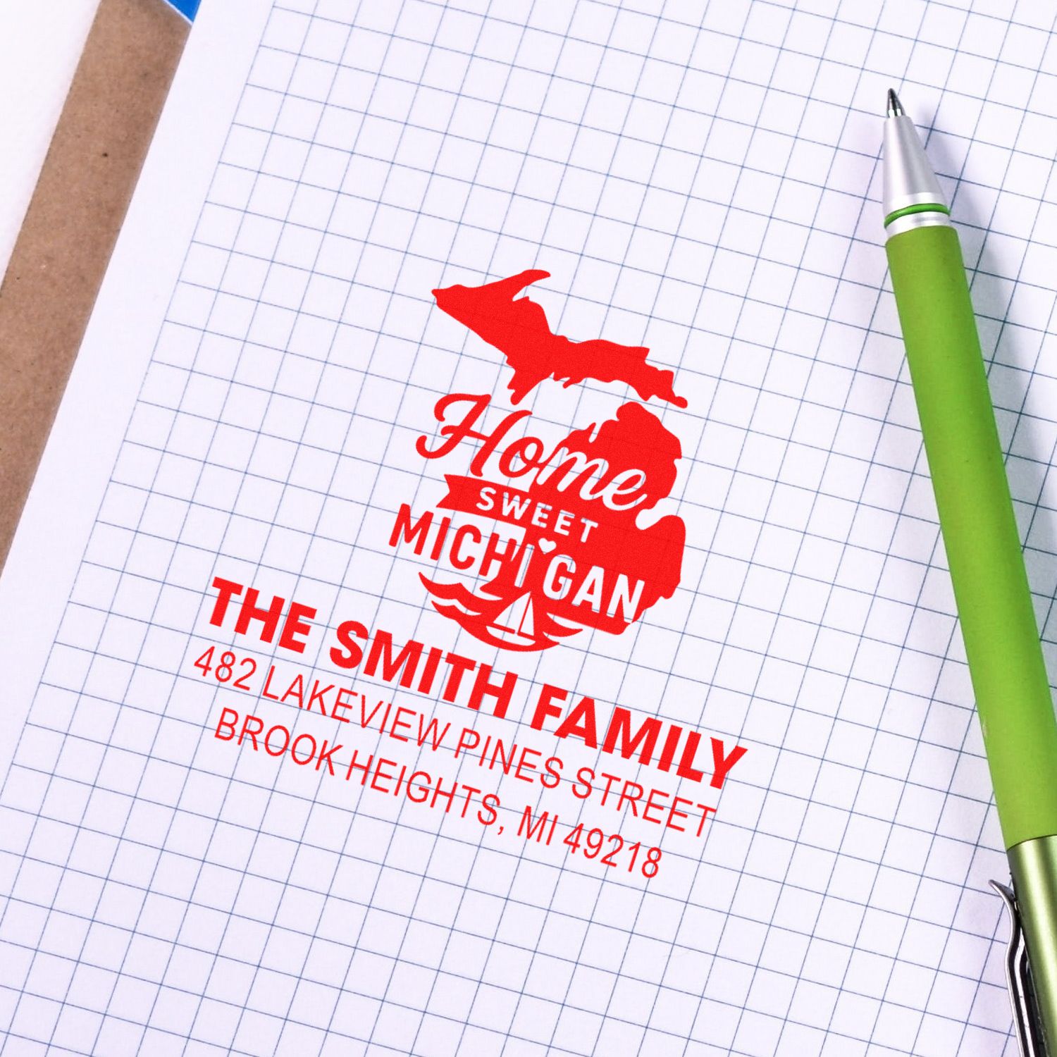 Custom rubber address stamp for a Michigan home, showing a family return address on graph paper for mailing and stationery.
