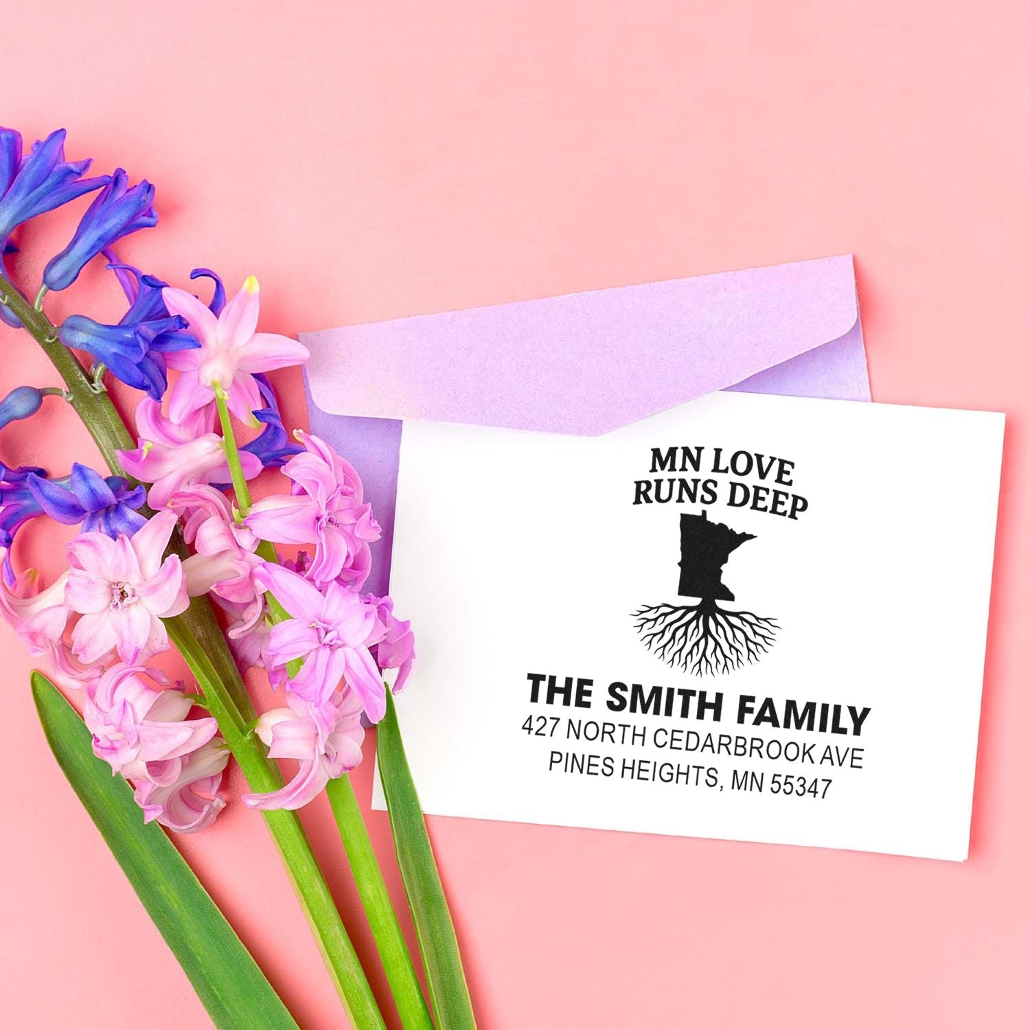Custom Minnesota family address rubber stamp on envelope with floral stationery, featuring MN Love Runs Deep and root design.
