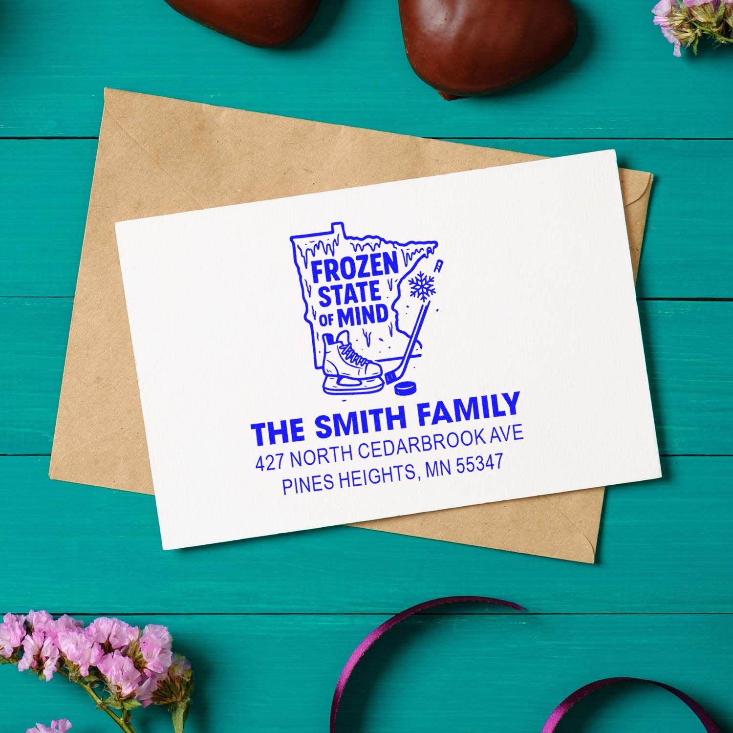 Custom family return address rubber stamp with Minnesota hockey design on an envelope for personalized mail.