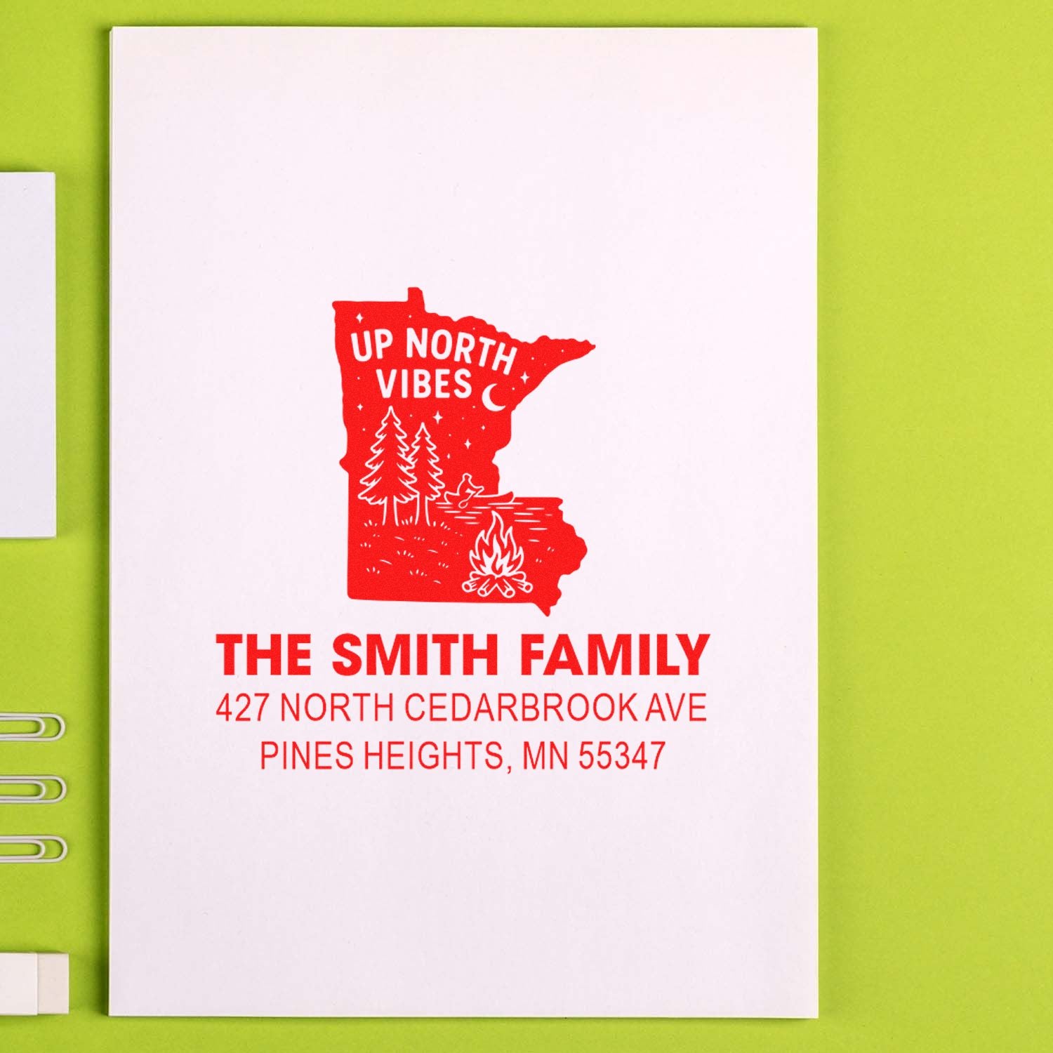Custom Minnesota address rubber stamp with Up North Vibes design, family name, and campfire on white paper.