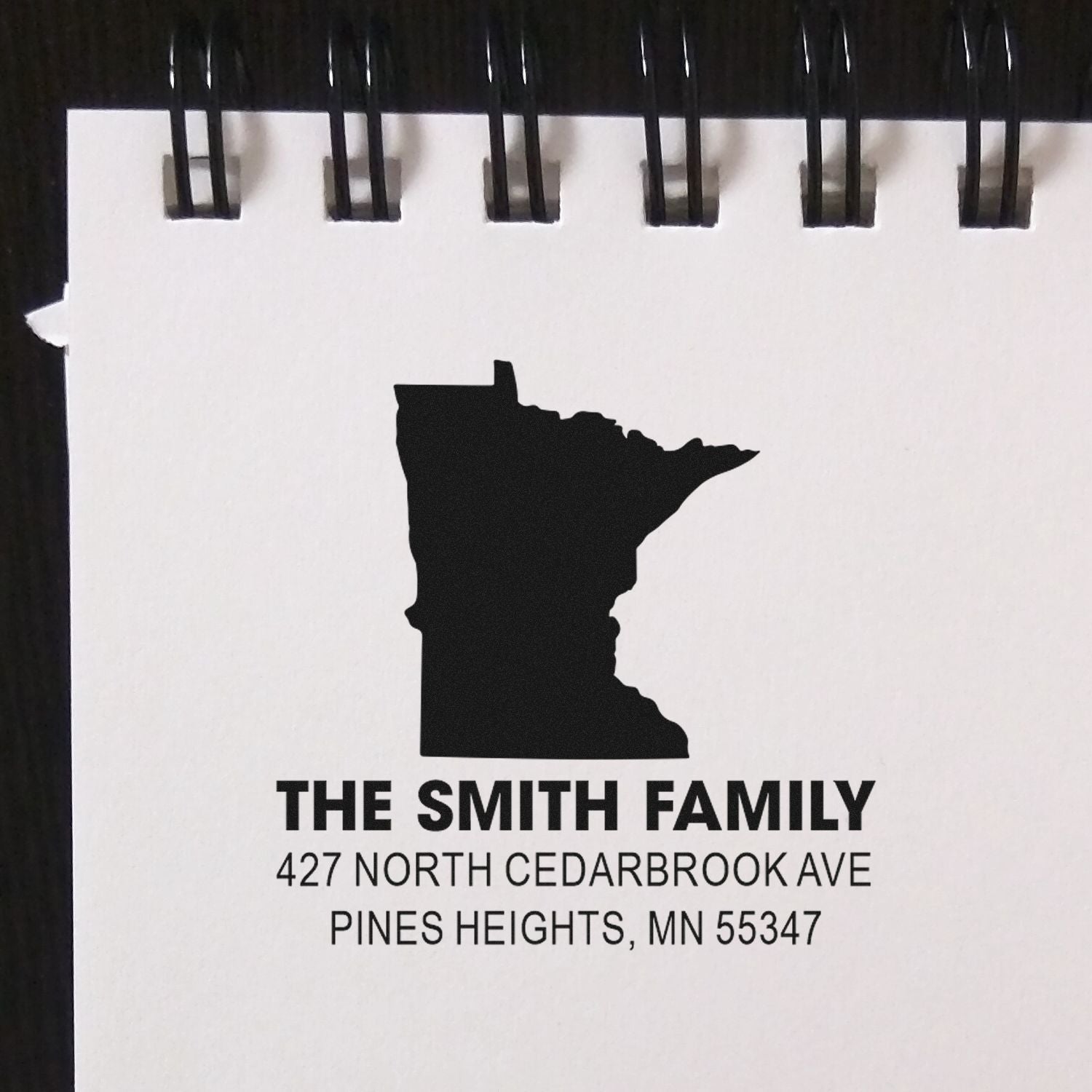 Custom return address rubber stamp with Minnesota silhouette, The Smith Family, and Pines Heights, MN mailing address.