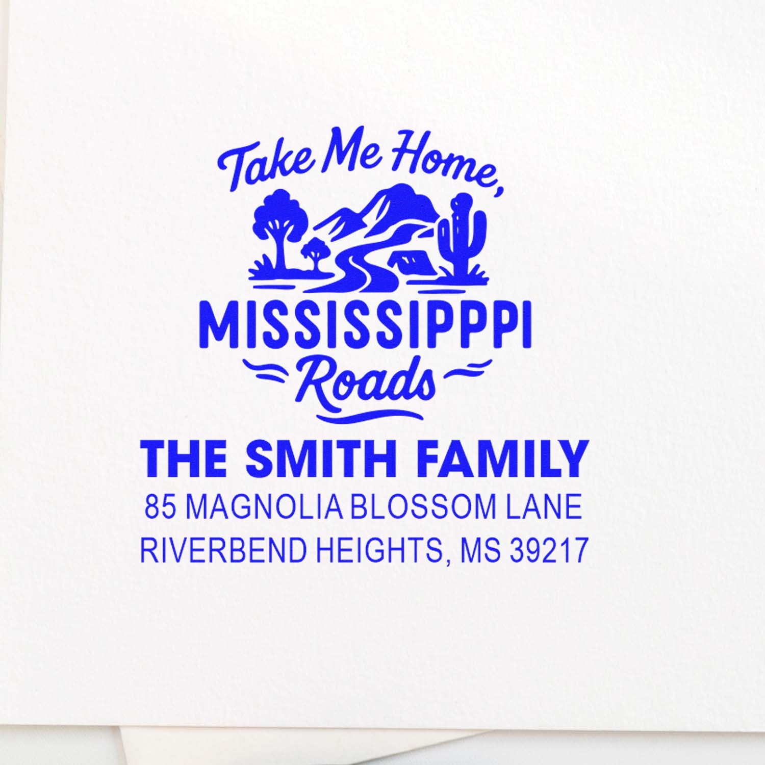 Custom return address rubber stamp with Take Me Home, Mississippi Roads design for The Smith Family, Riverbend Heights, MS 39217.